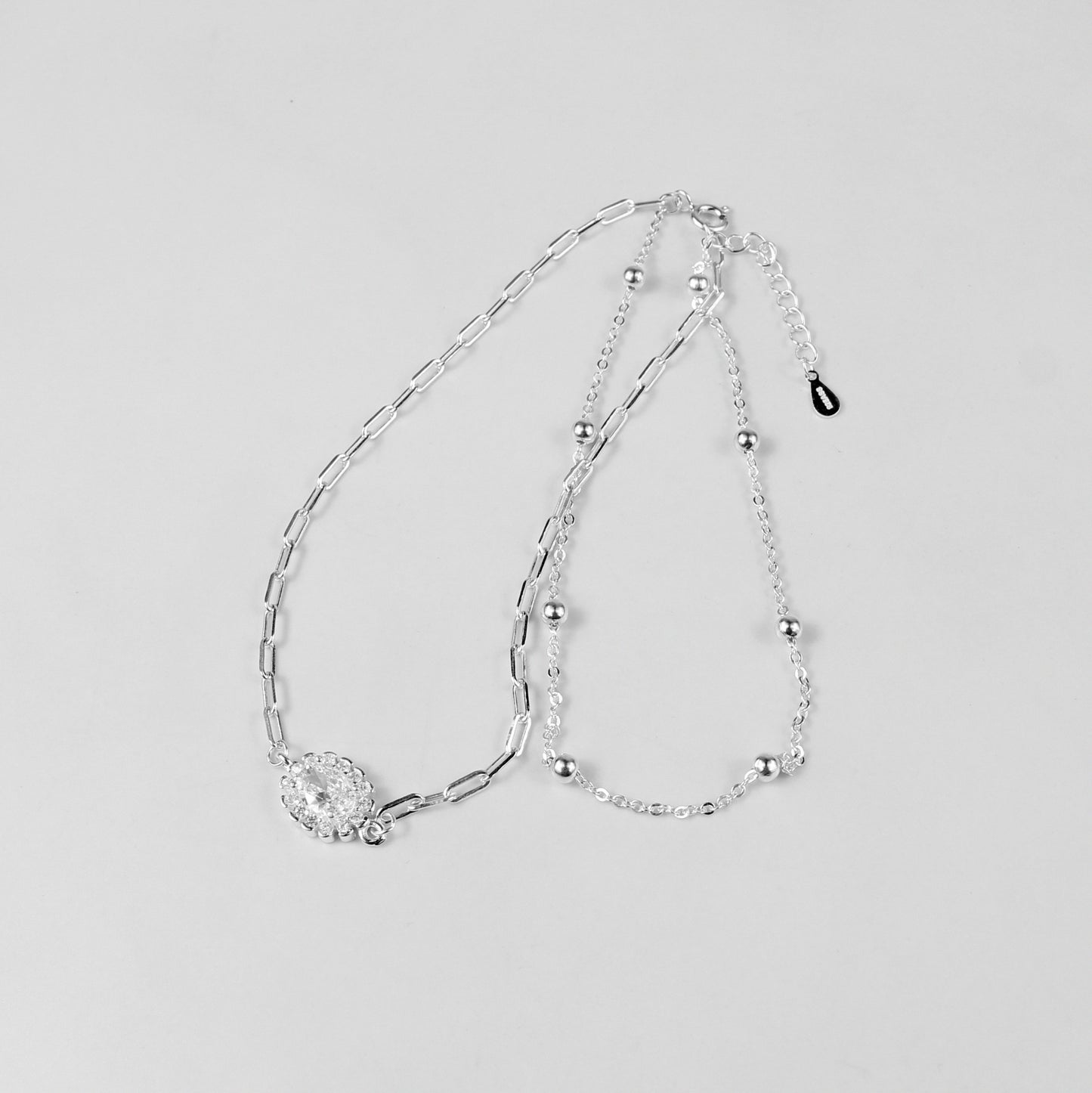 A sophisticated set of 'Serein Anklets,' made with 925 sterling silver, blending timeless elegance with a serene and flowing design.