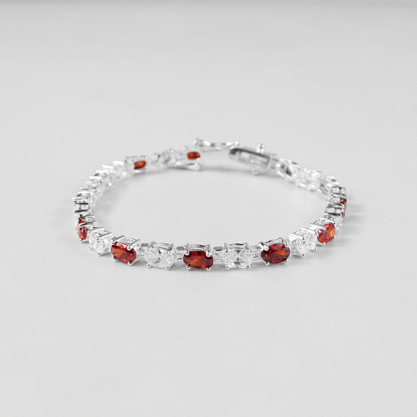 The 'Crimson Radiance' bracelet, an exquisite piece of 925 sterling silver jewelry, blending timeless sophistication with the vibrant allure of crimson tones.
