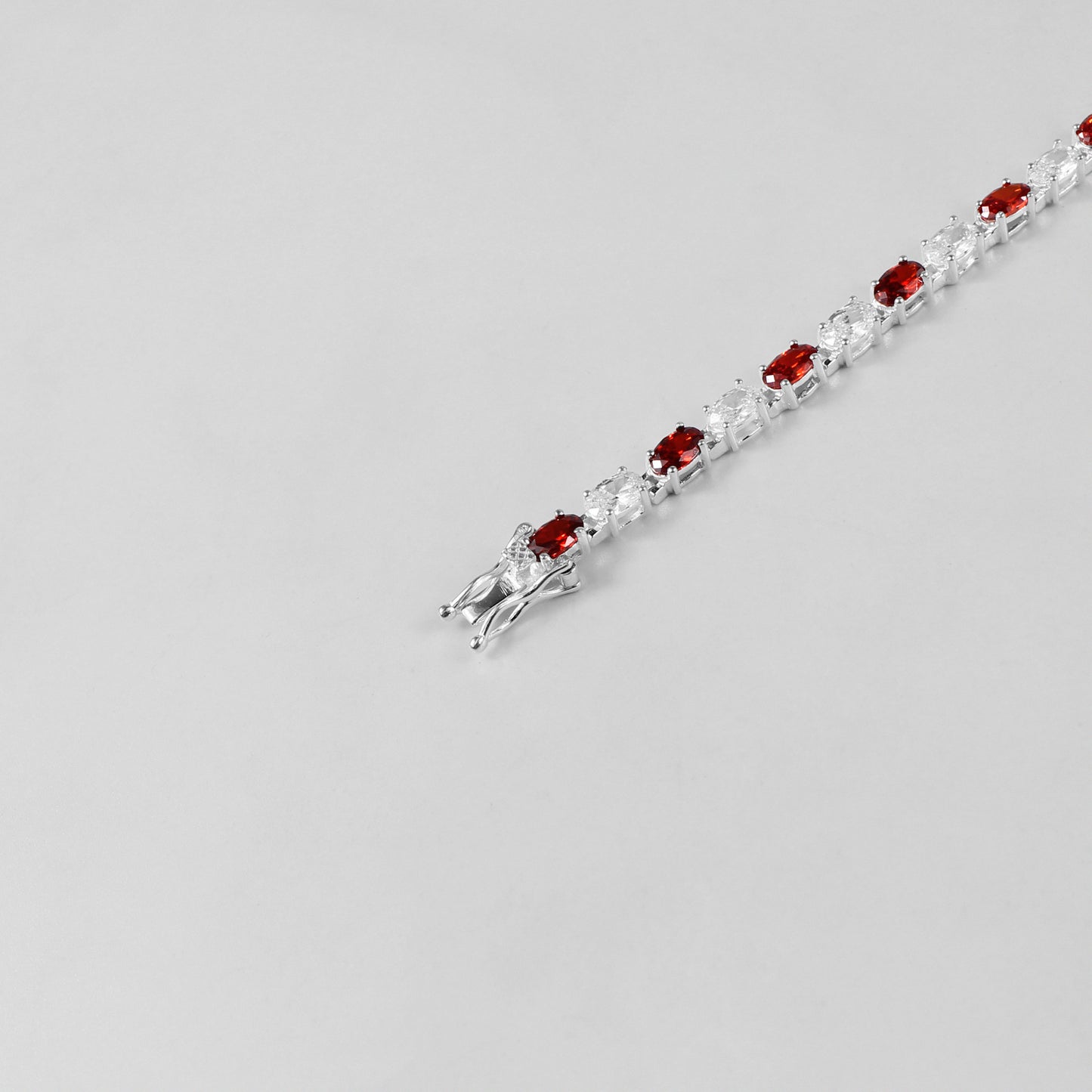The 'Crimson Radiance' bracelet, an exquisite piece of 925 sterling silver jewelry, blending timeless sophistication with the vibrant allure of crimson tones.
