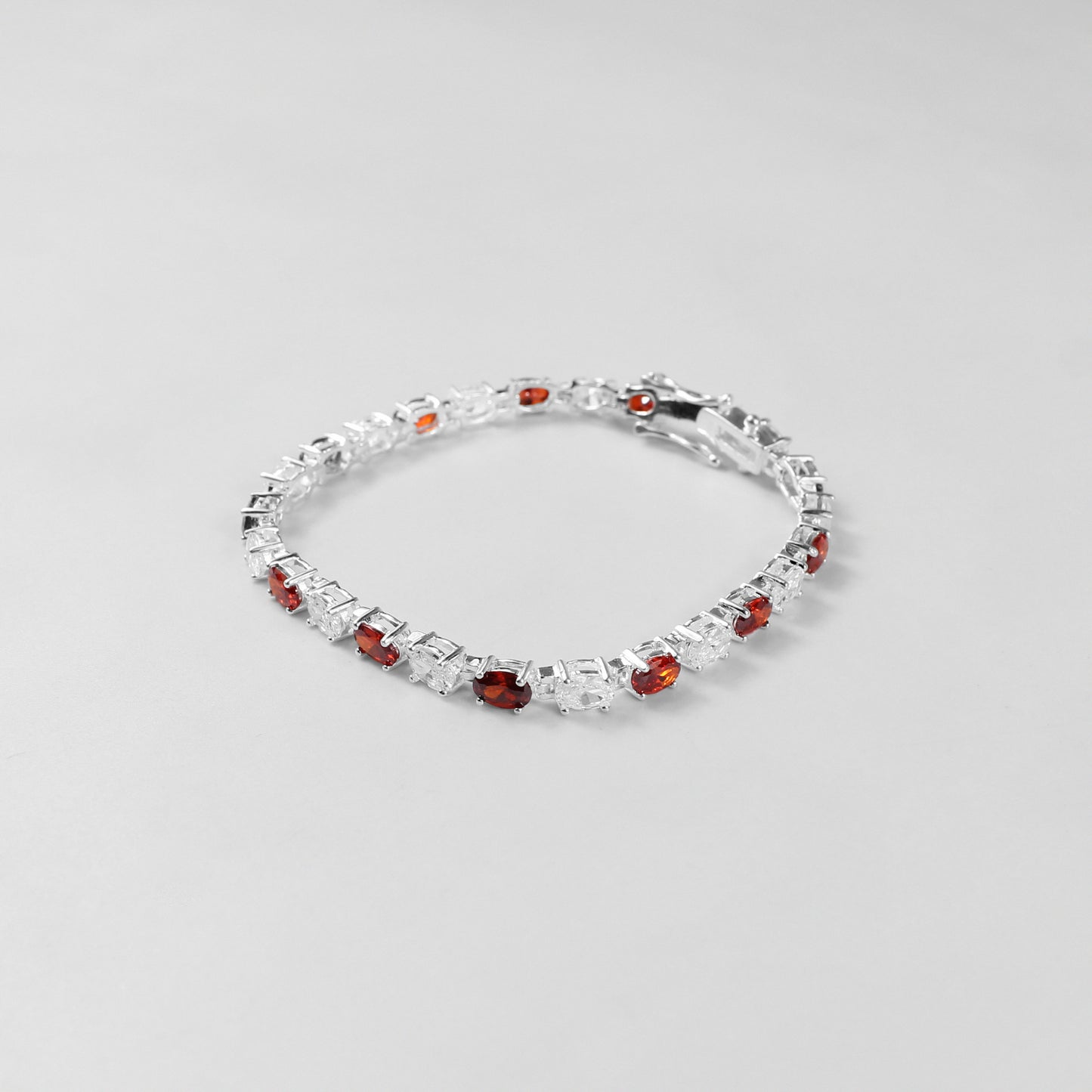 The 'Crimson Radiance' bracelet, an exquisite piece of 925 sterling silver jewelry, blending timeless sophistication with the vibrant allure of crimson tones.
