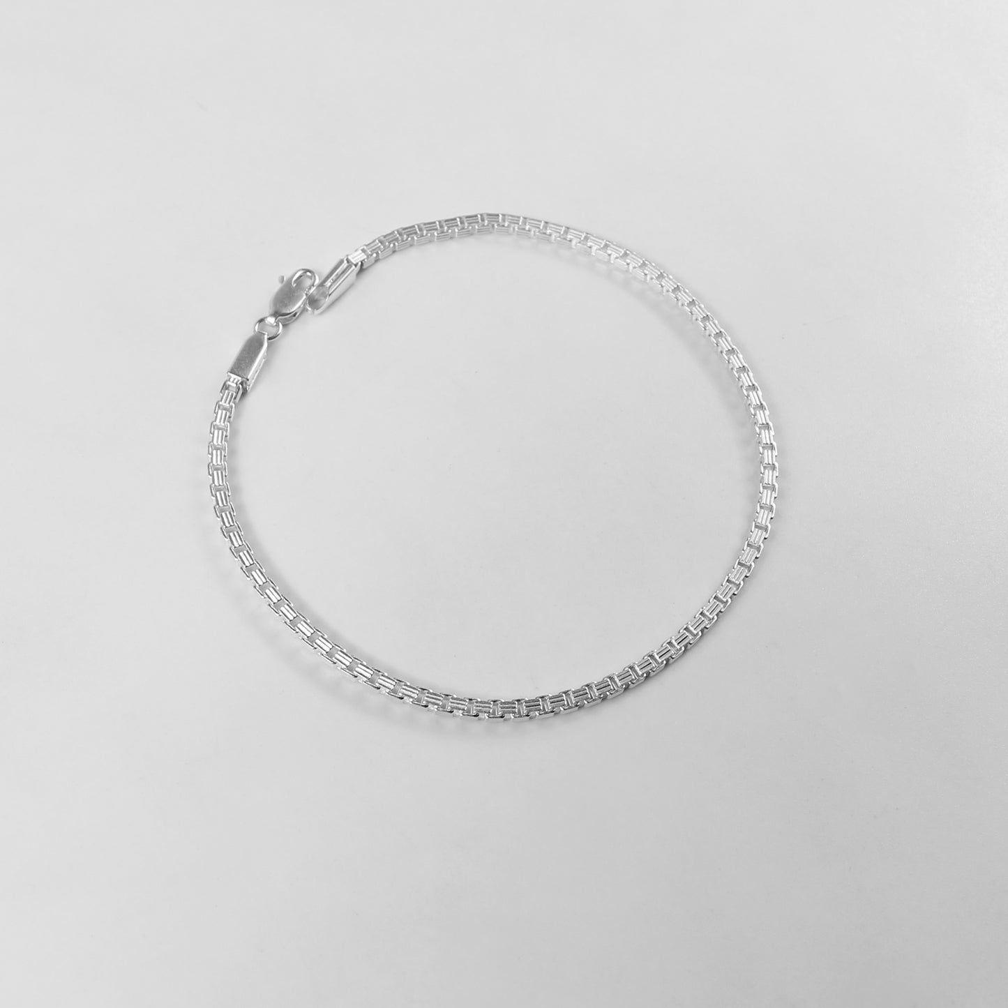 The 'Silken Glide' bracelet, crafted from 925 sterling silver, featuring a smooth and fluid design that embodies effortless grace.