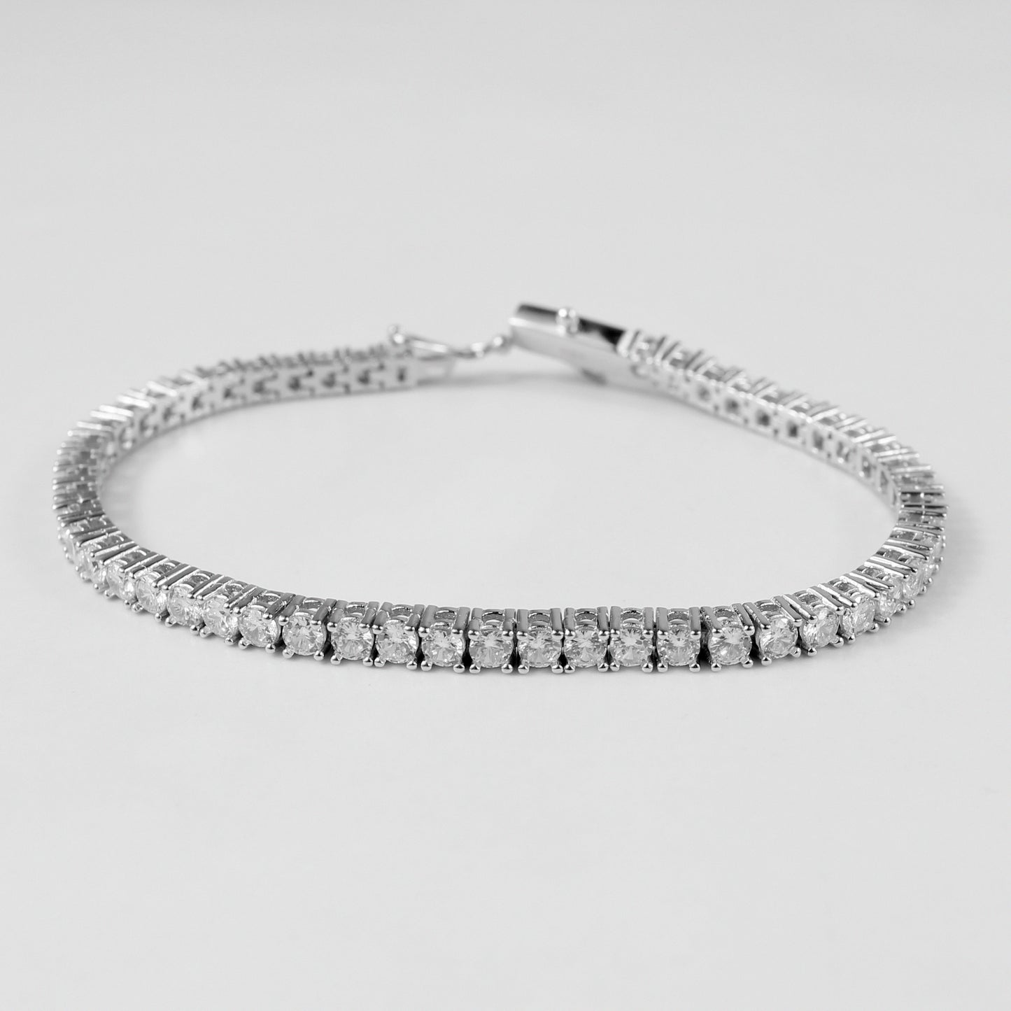 Tennis Bracelet - A classic 925 sterling silver bracelet by GetTheJuice, featuring a continuous row of sparkling stones that add timeless elegance and sophistication to any wrist.