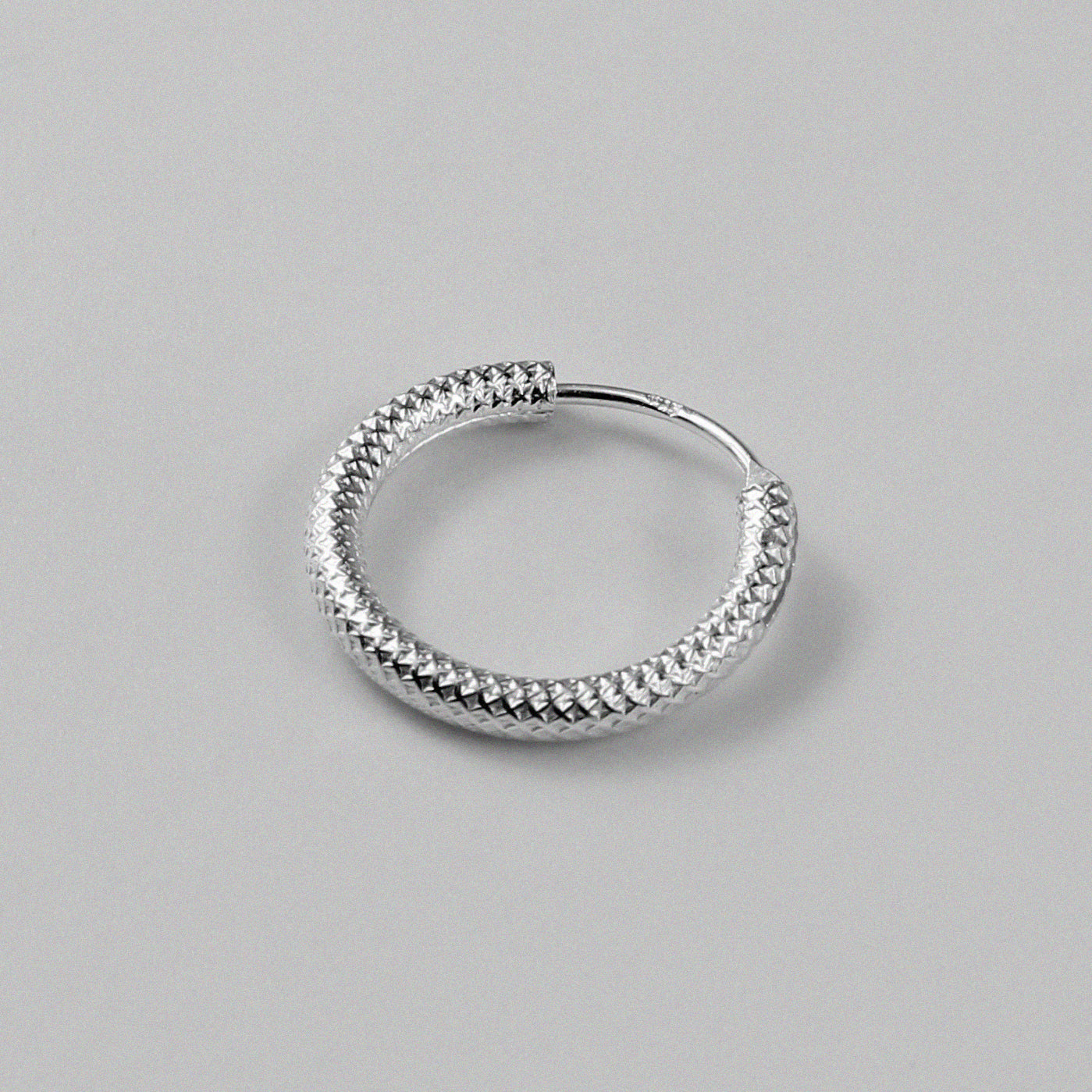 Stardust Circlets Earrings - A stunning pair of 925 sterling silver earrings by GetTheJuice, showcasing intricate circlets adorned with sparkling stardust, perfect for enhancing your ensemble with a hint of cosmic elegance.