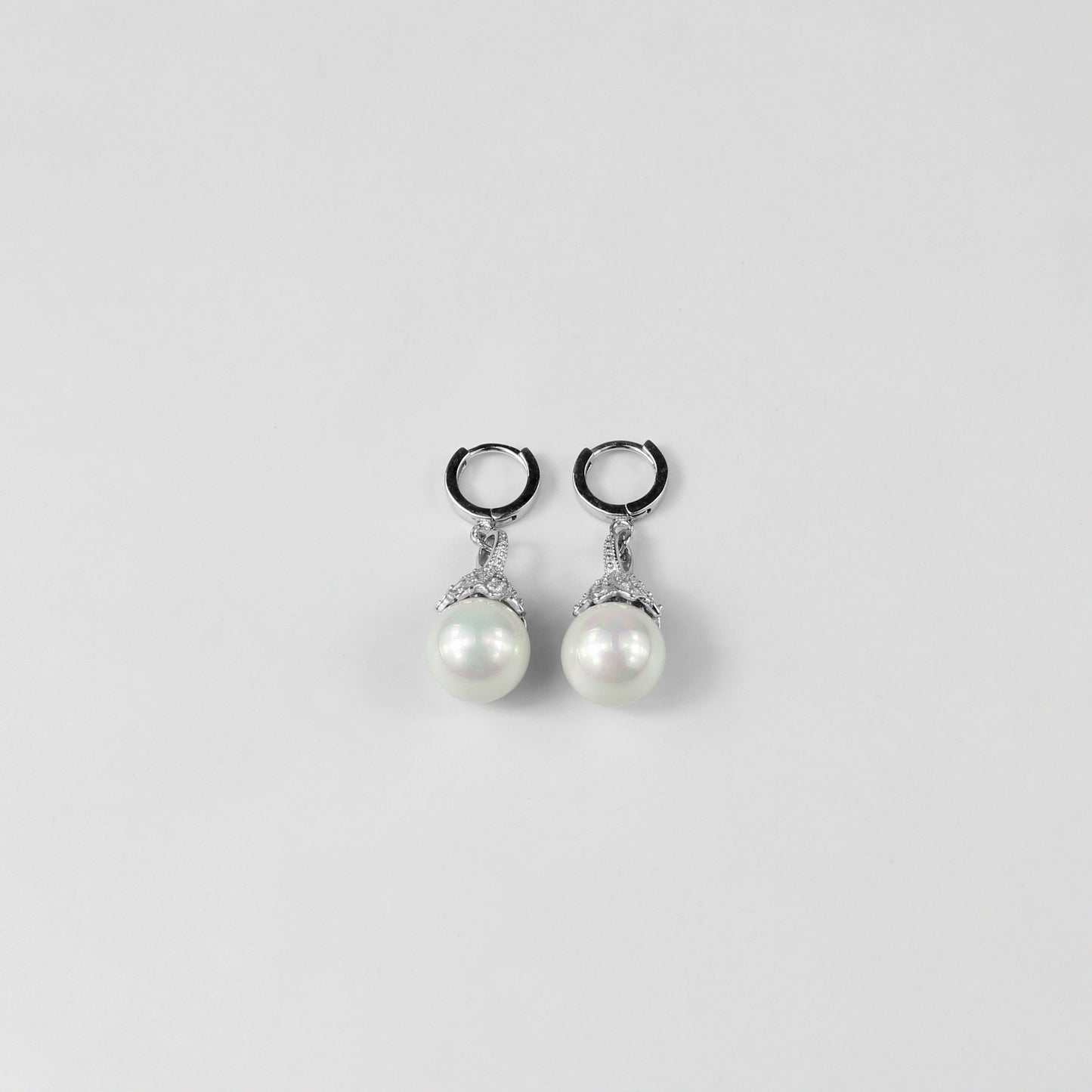 A pair of dazzling 925 sterling silver ear studs featuring radiant pearls that evoke the beauty of an aurora. The design captures a sense of elegance and ethereal charm, making these studs a striking accessory for any occasion.