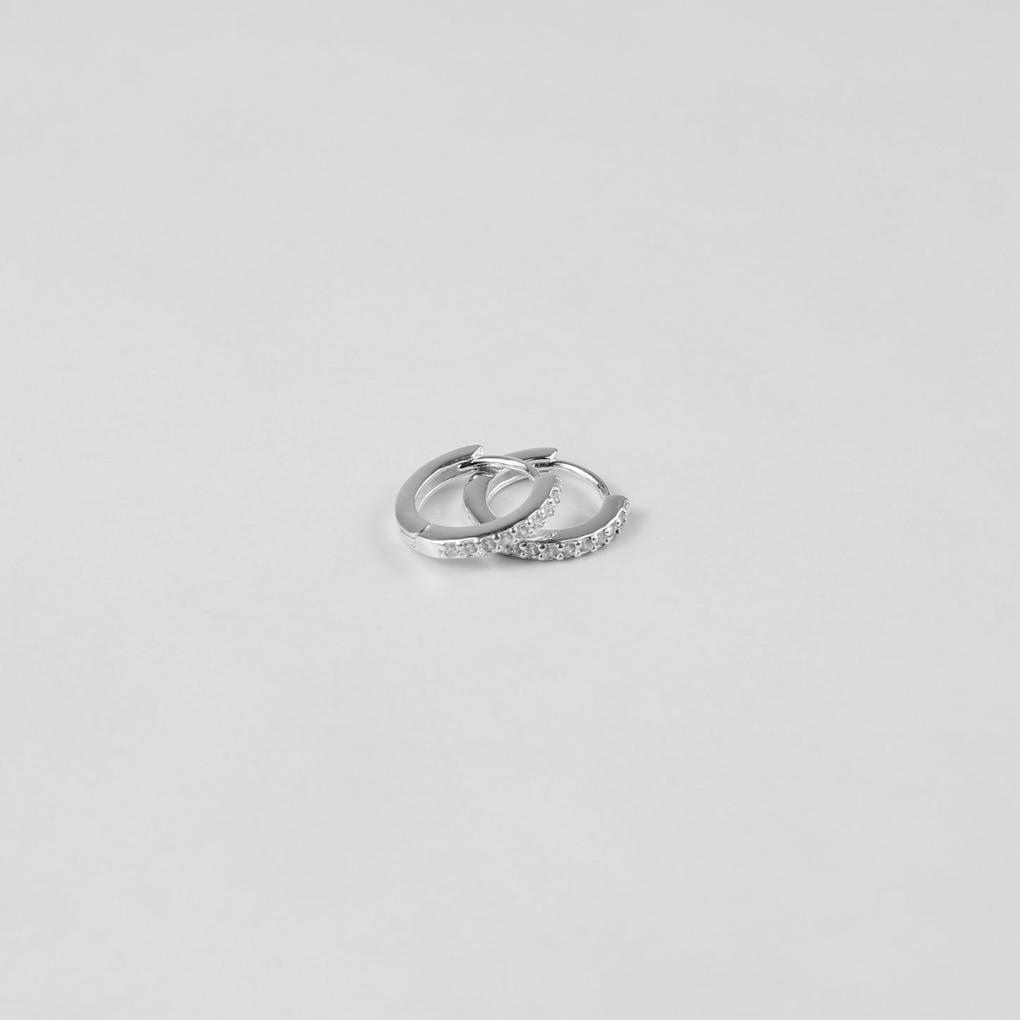 Elegant crystal halo ear studs crafted from 925 sterling silver, showcased on a white surface. The shimmering crystals catch the light beautifully, enhancing their sophisticated design.