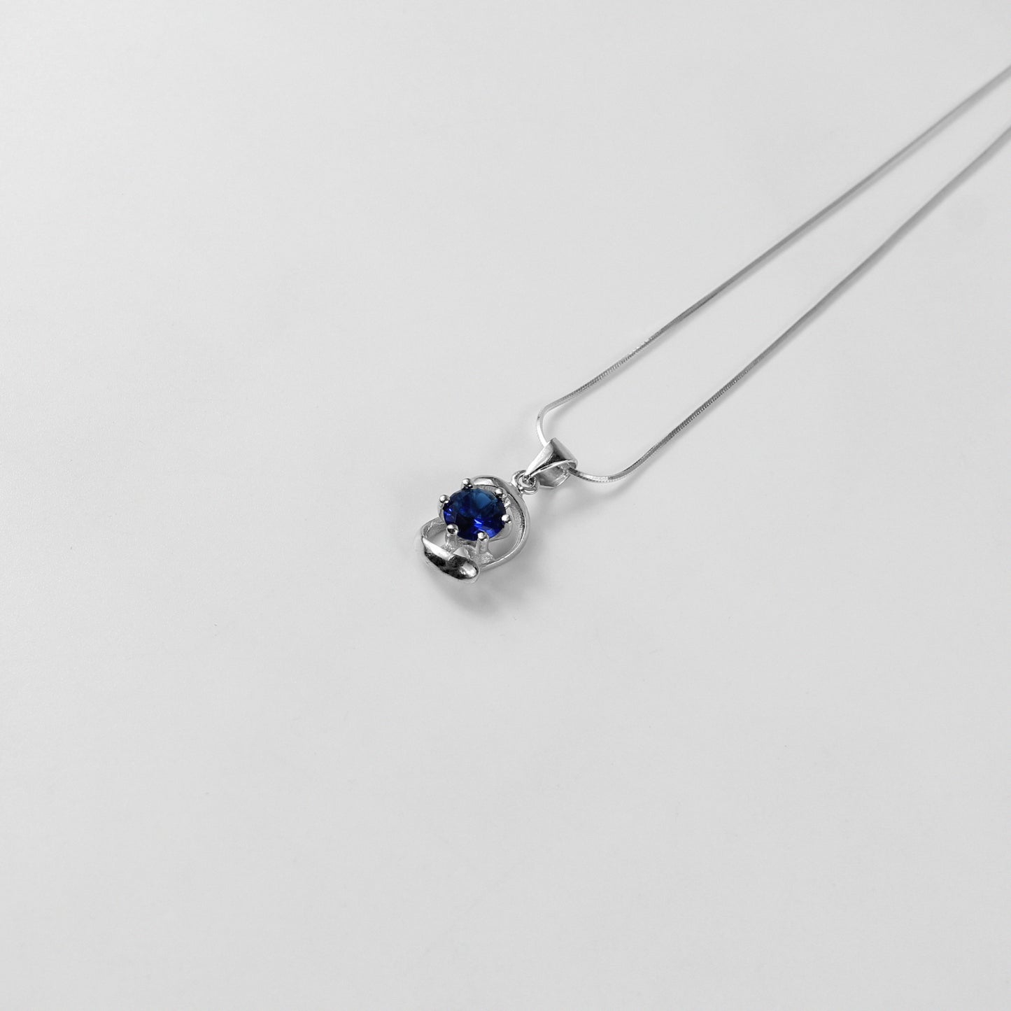 A striking necklace named 'Blue Echo,' crafted from 925 sterling silver. Its design features vibrant blue accents, evoking a sense of calm and sophistication with a modern edge.