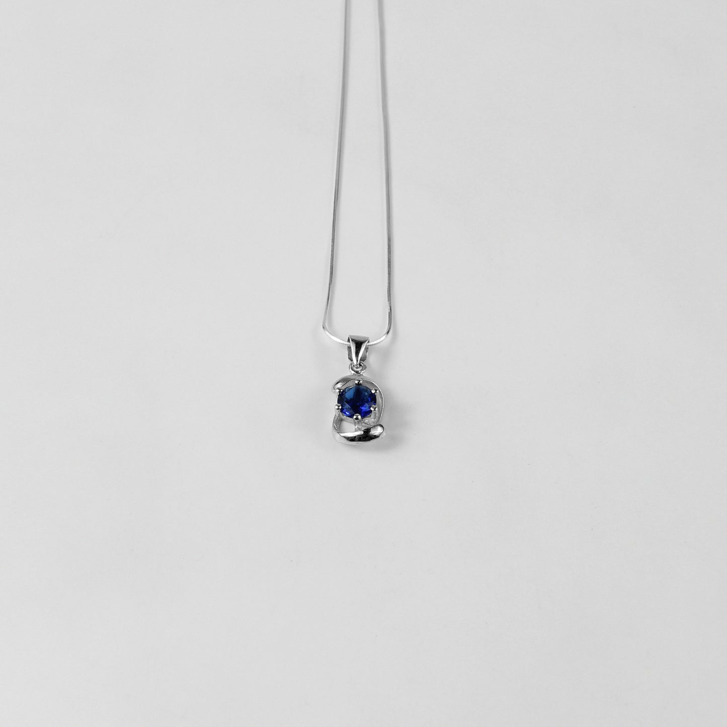 A striking necklace named 'Blue Echo,' crafted from 925 sterling silver. Its design features vibrant blue accents, evoking a sense of calm and sophistication with a modern edge.