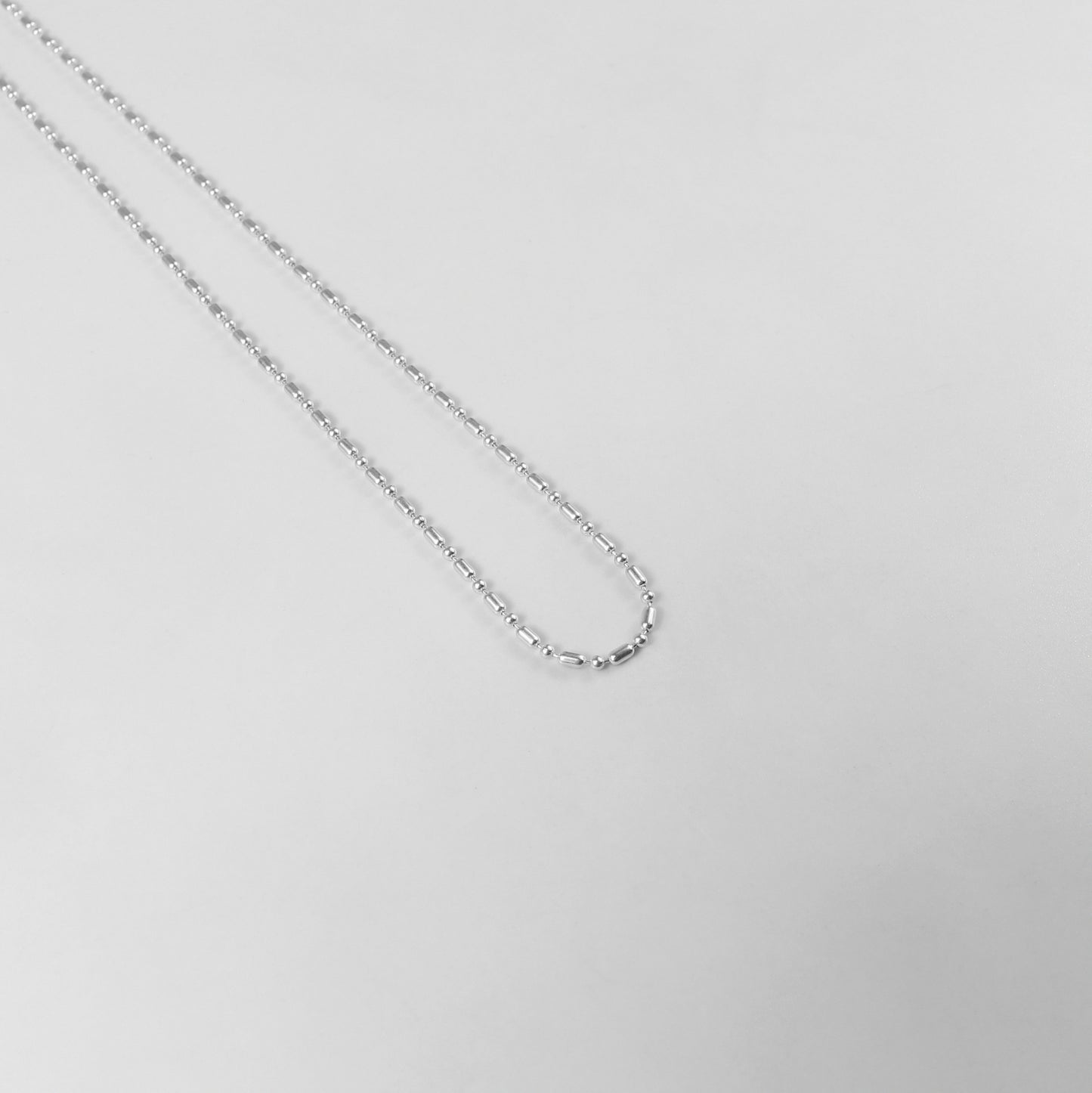 925 sterling silver necklace named 'Ethereal Silver Bead,' featuring a delicate strand of luminous silver beads that exude elegance and simplicity. Its refined design captures an otherworldly charm, making it a versatile accessory for both casual and formal occasions.