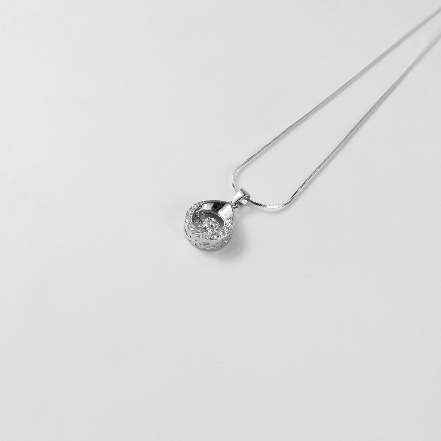 A stunning necklace named 'Glacia,' crafted from 925 sterling silver. Its design evokes the pristine elegance of icy landscapes, radiating a cool and sophisticated charm.