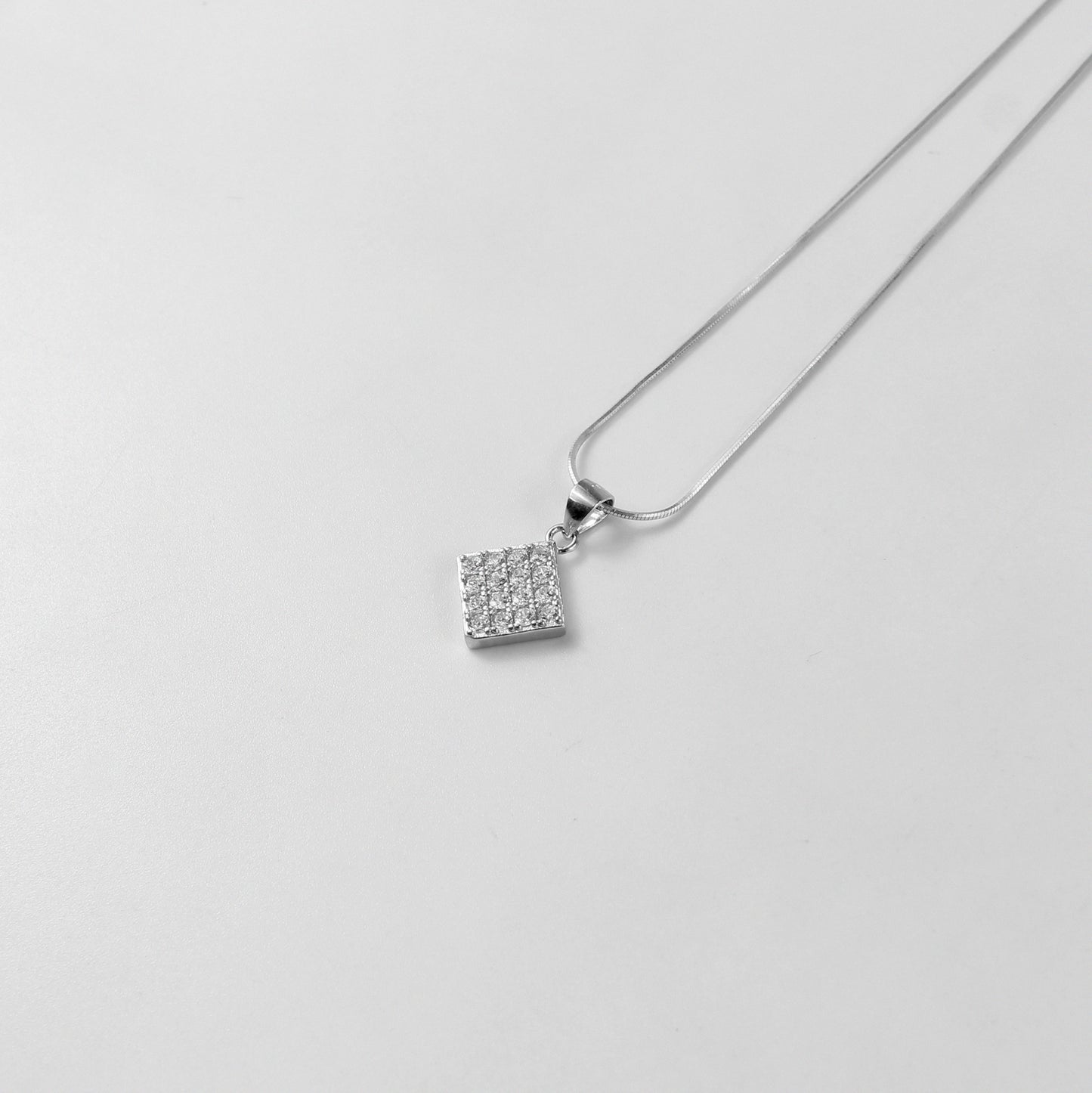 A graceful necklace named 'Glacial Beauty,' crafted from 925 sterling silver. Its design reflects the serene elegance of icy landscapes, exuding a cool and timeless allure.