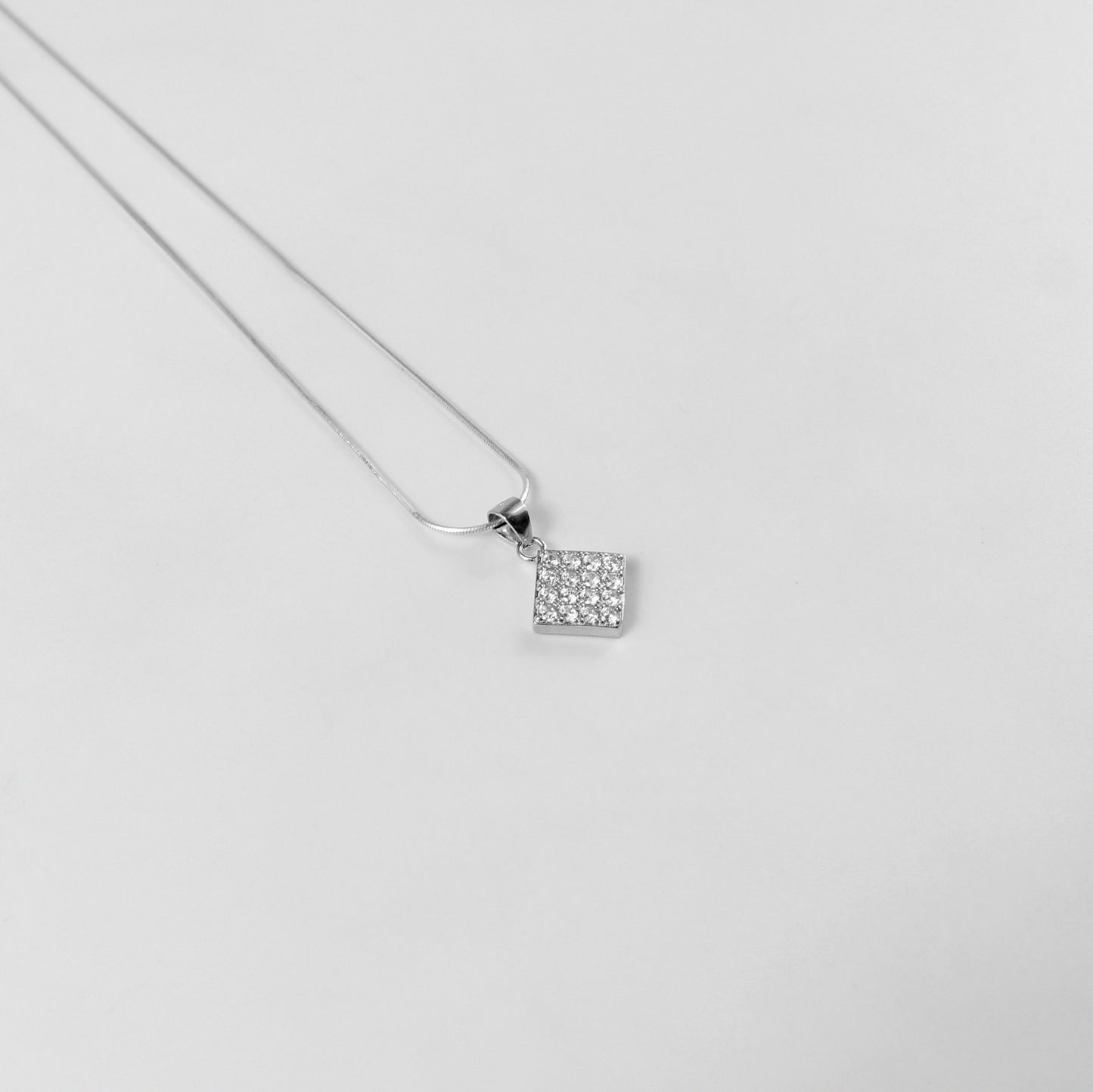 A graceful necklace named 'Glacial Beauty,' crafted from 925 sterling silver. Its design reflects the serene elegance of icy landscapes, exuding a cool and timeless allure.