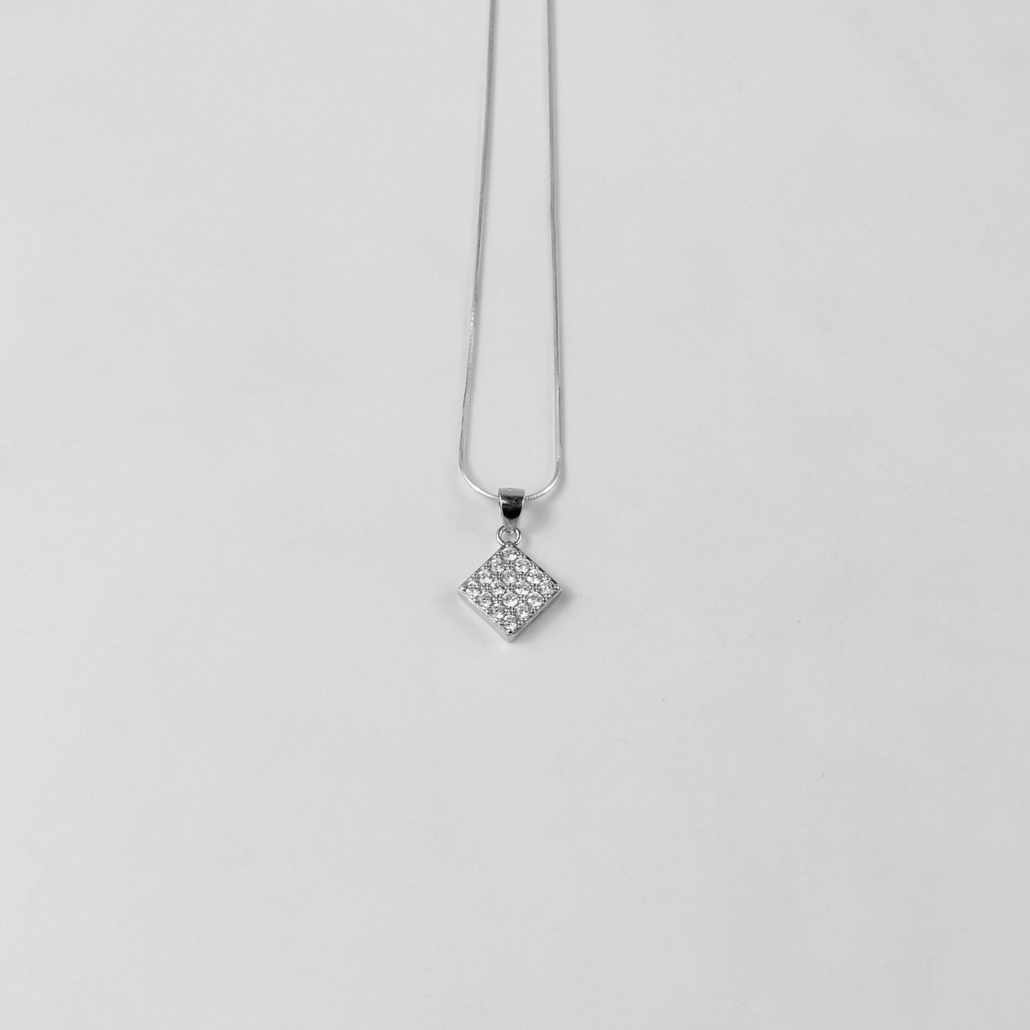 A graceful necklace named 'Glacial Beauty,' crafted from 925 sterling silver. Its design reflects the serene elegance of icy landscapes, exuding a cool and timeless allure.