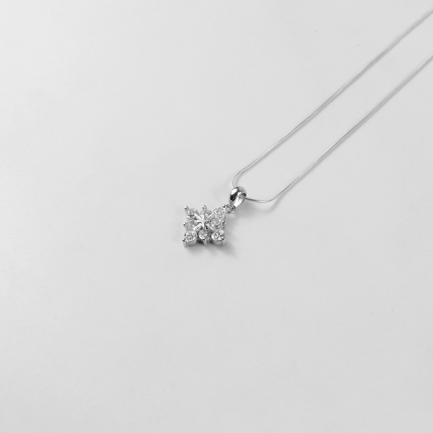An elegant necklace named 'Lumine,' crafted from 925 sterling silver. Its radiant design captures the essence of light and brilliance, exuding a timeless and luminous charm.