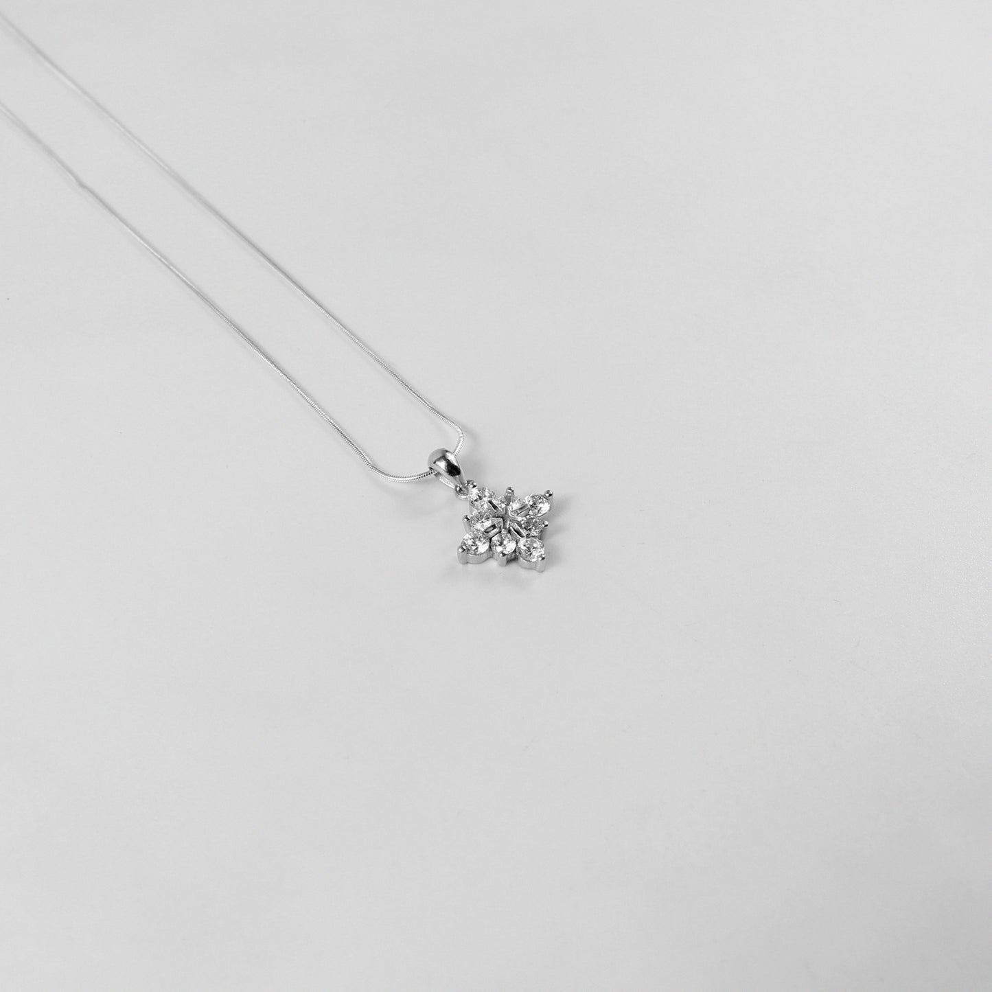 An elegant necklace named 'Lumine,' crafted from 925 sterling silver. Its radiant design captures the essence of light and brilliance, exuding a timeless and luminous charm.