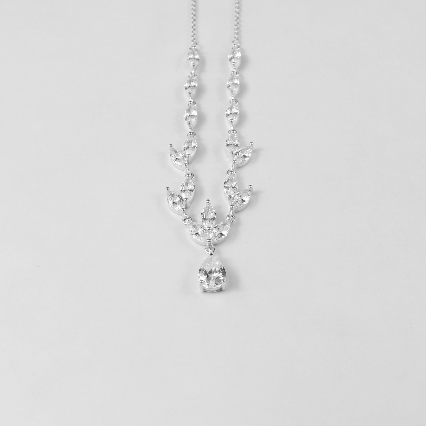 An elegant necklace named 'Moonlit Grace,' crafted from 925 sterling silver. Its design captures the serene beauty of moonlight with a graceful and timeless aesthetic.