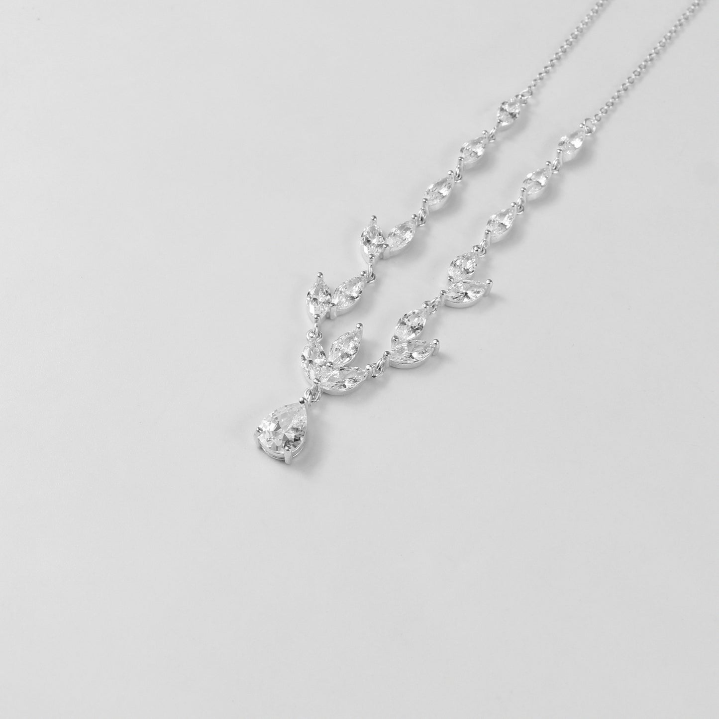 An elegant necklace named 'Moonlit Grace,' crafted from 925 sterling silver. Its design captures the serene beauty of moonlight with a graceful and timeless aesthetic.