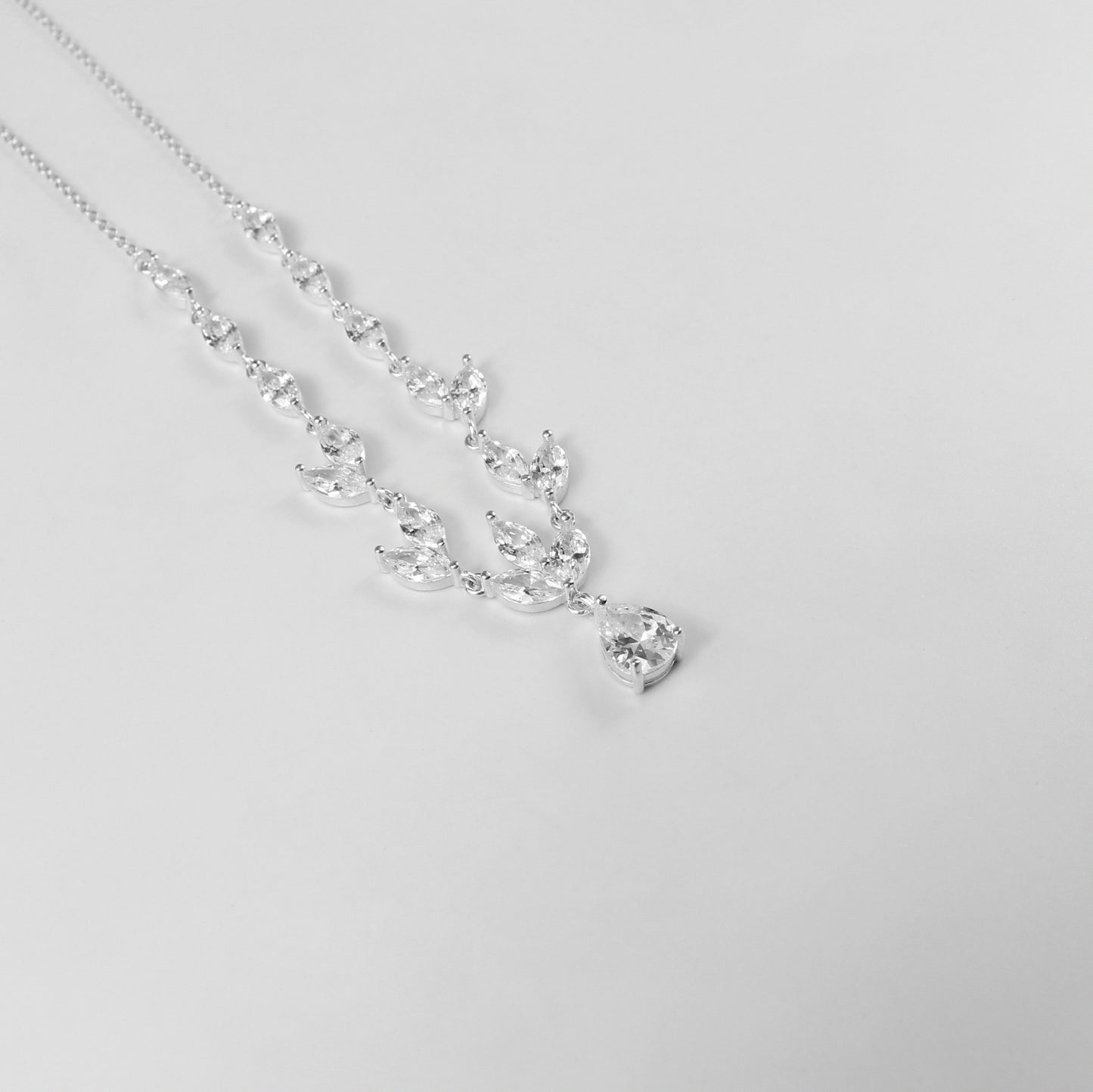 An elegant necklace named 'Moonlit Grace,' crafted from 925 sterling silver. Its design captures the serene beauty of moonlight with a graceful and timeless aesthetic.
