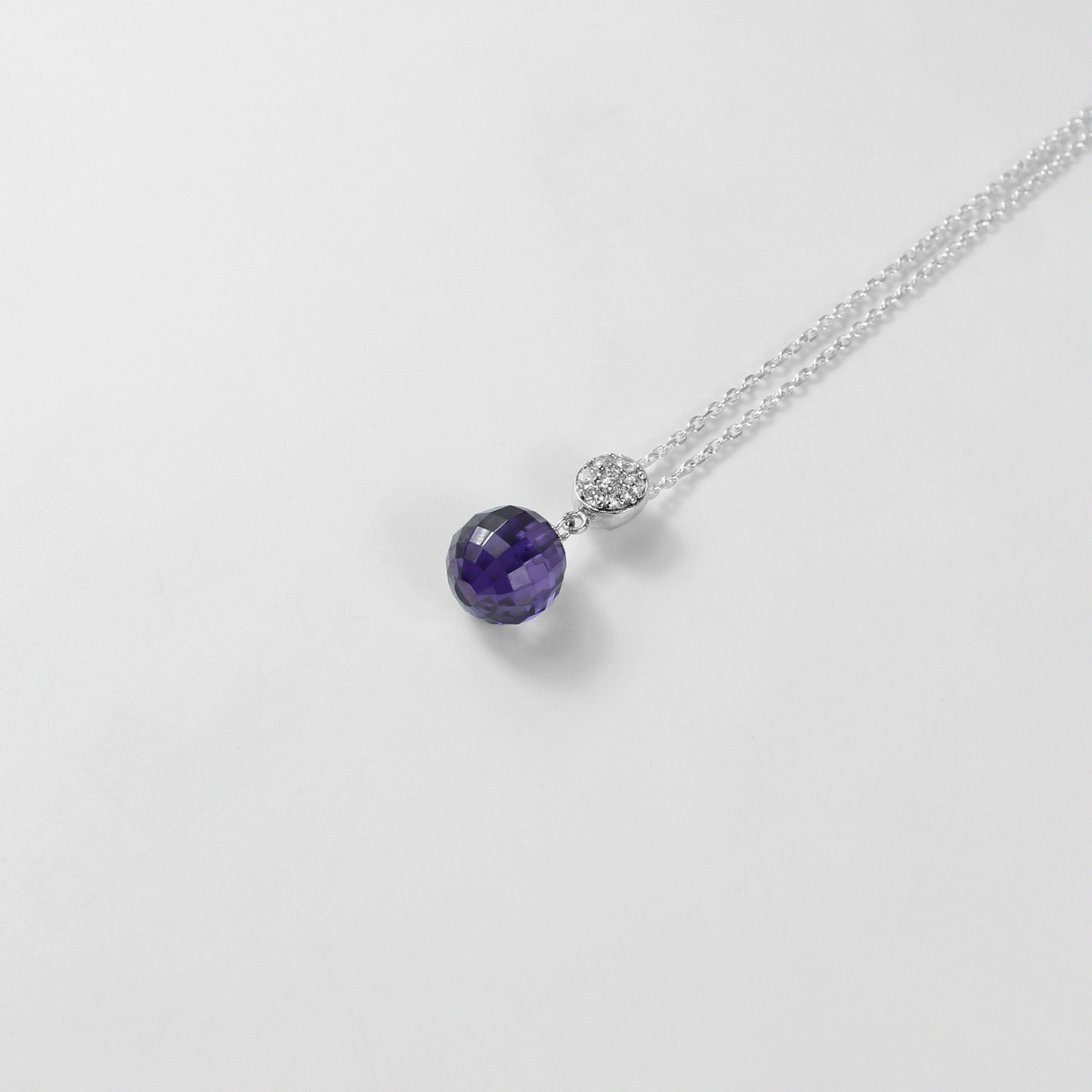 A beautiful necklace named 'Purple Charm,' crafted from 925 sterling silver. Its design features enchanting purple accents, exuding elegance and a touch of mystique.