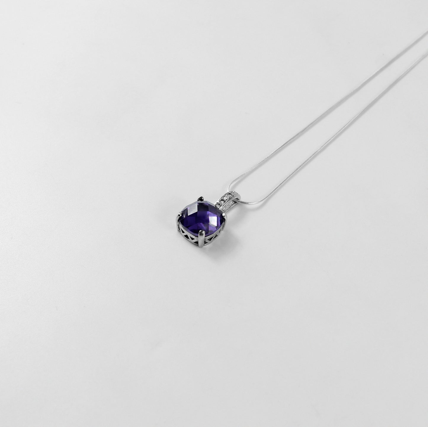 An elegant necklace named 'Purple Glow,' crafted from 925 sterling silver. Its design features radiant purple accents that emit a soft, luminous charm, perfect for adding a touch of sophistication.
