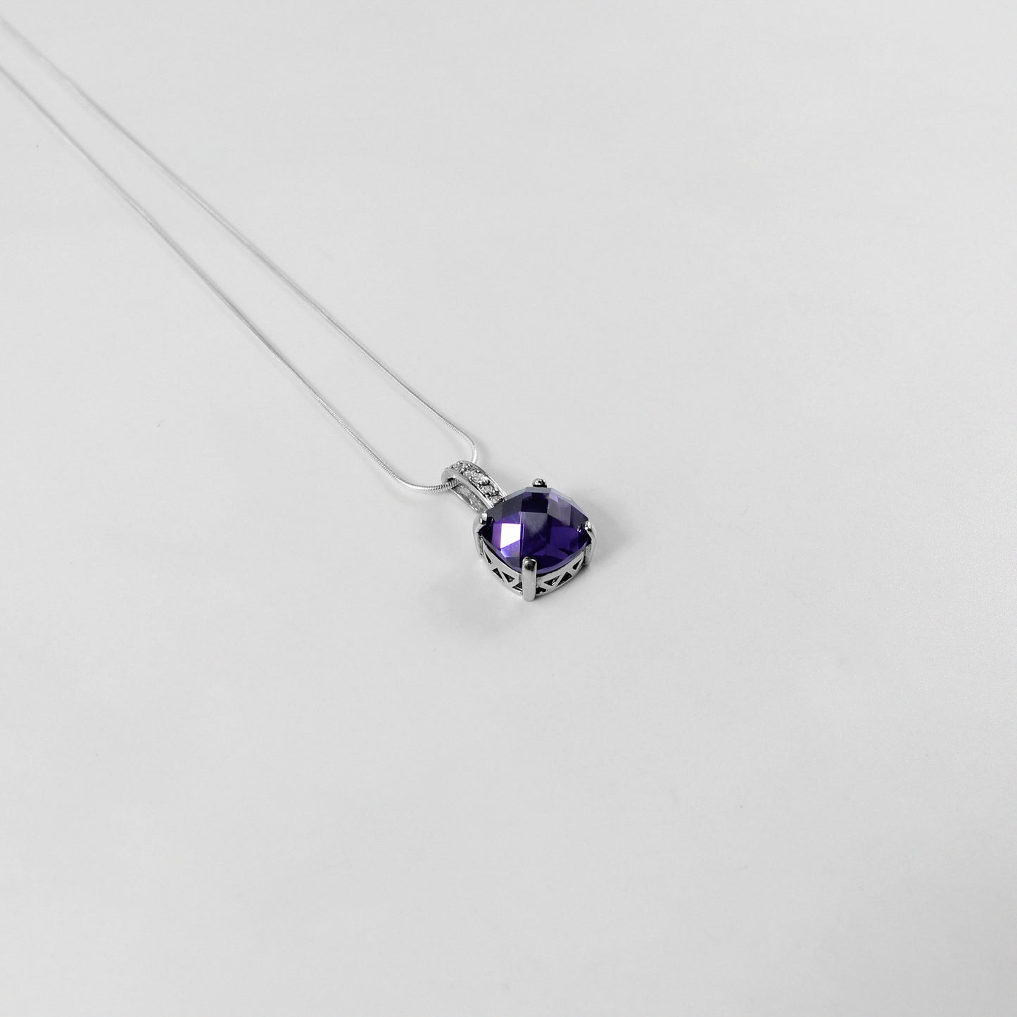 An elegant necklace named 'Purple Glow,' crafted from 925 sterling silver. Its design features radiant purple accents that emit a soft, luminous charm, perfect for adding a touch of sophistication.