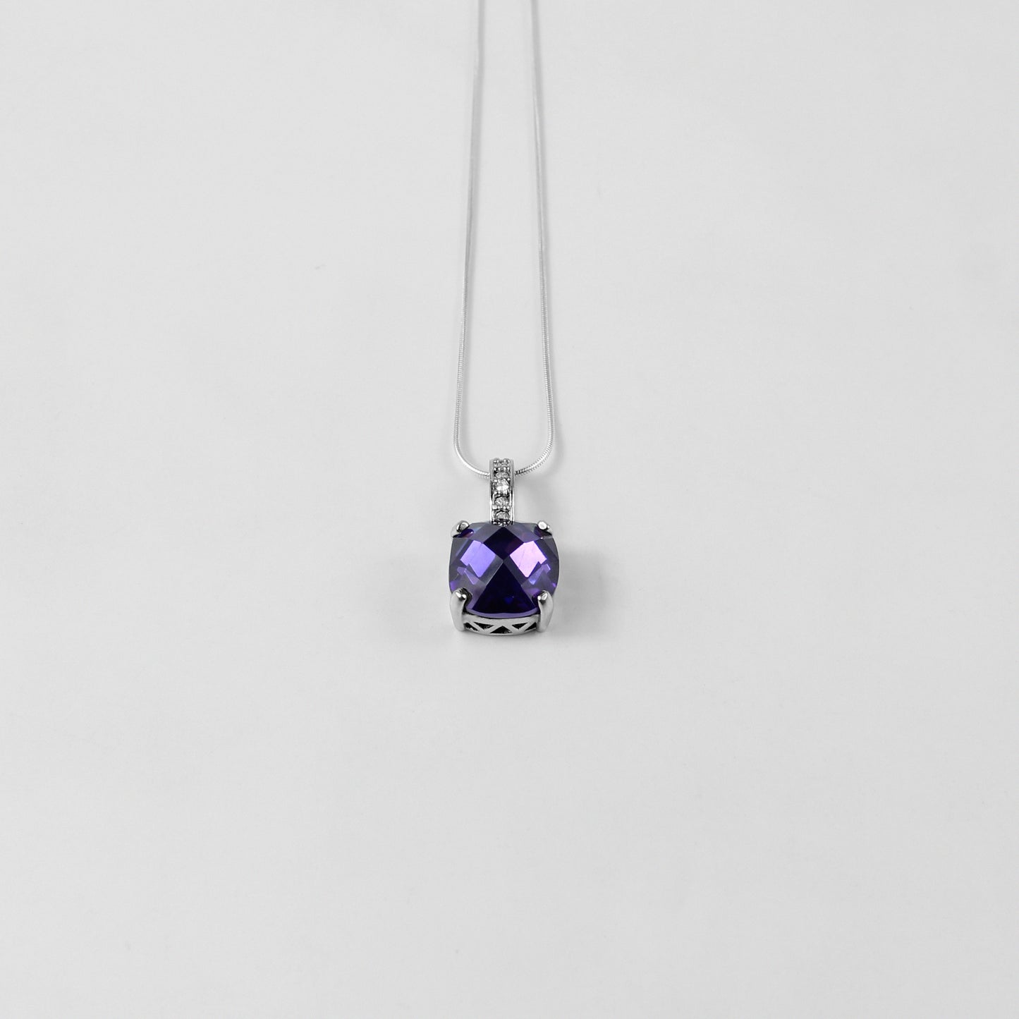 An elegant necklace named 'Purple Glow,' crafted from 925 sterling silver. Its design features radiant purple accents that emit a soft, luminous charm, perfect for adding a touch of sophistication.