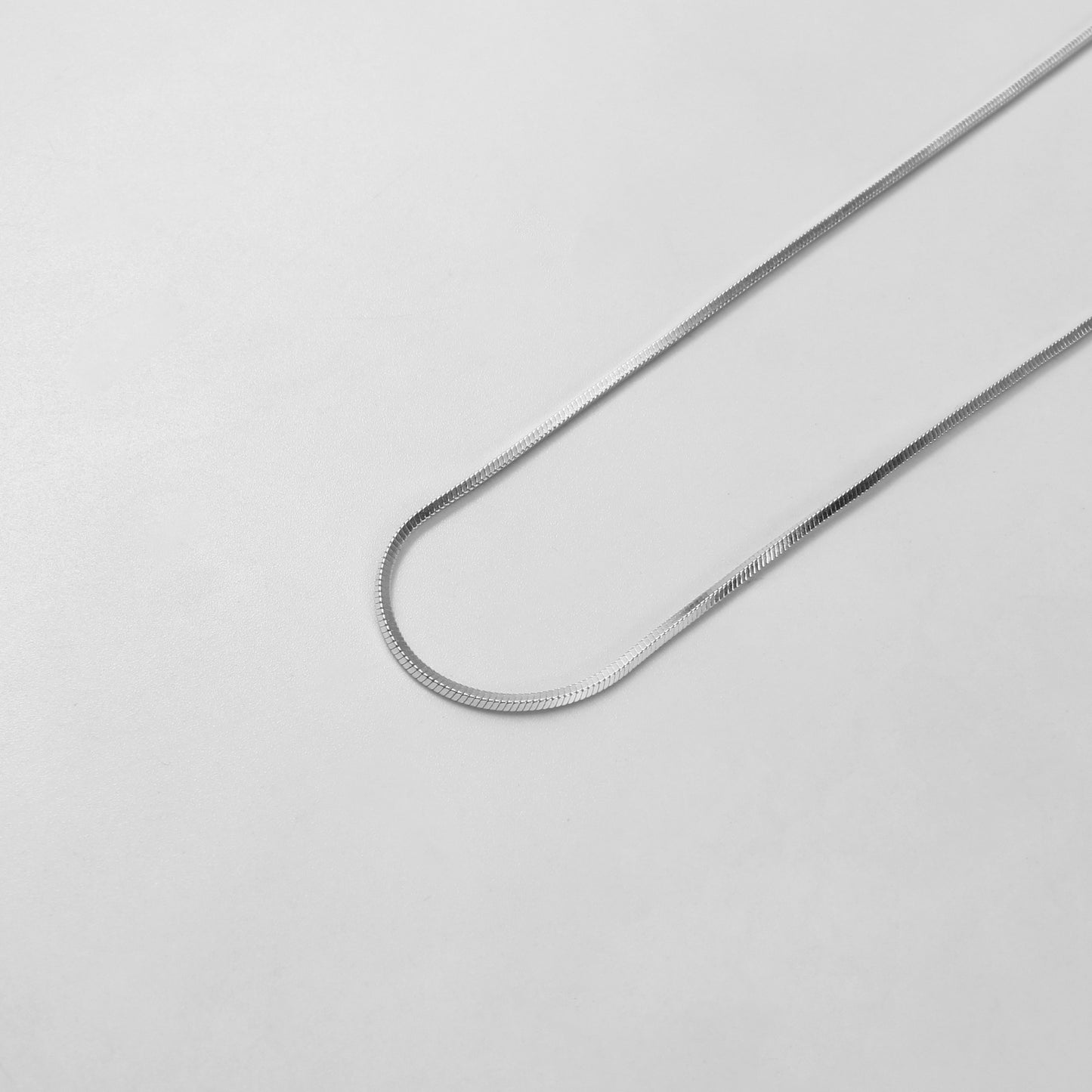 925 sterling silver necklace named 'Radiant Veil,' featuring a graceful design that combines flowing lines with delicate sparkling accents. Its ethereal beauty evokes the elegance of a shimmering veil, making it a timeless and captivating accessory.