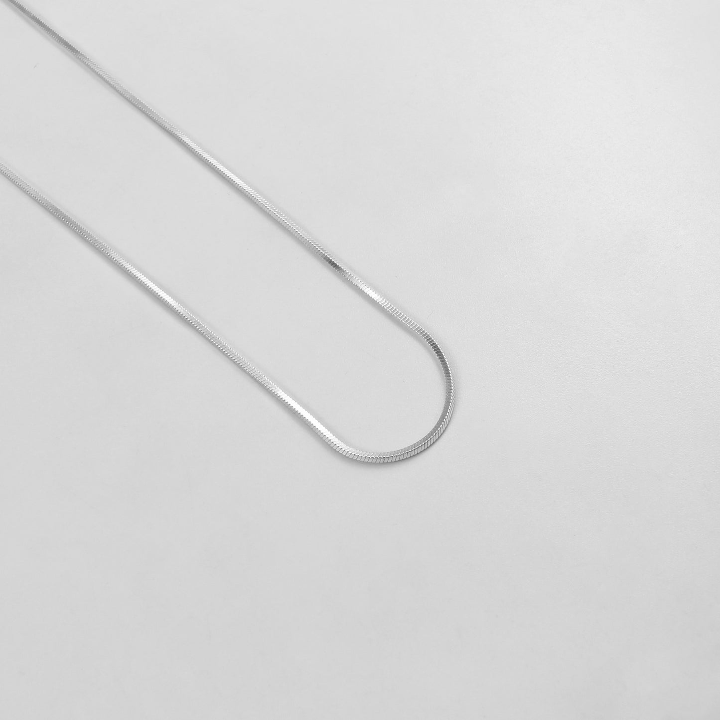925 sterling silver necklace named 'Radiant Veil,' featuring a graceful design that combines flowing lines with delicate sparkling accents. Its ethereal beauty evokes the elegance of a shimmering veil, making it a timeless and captivating accessory.