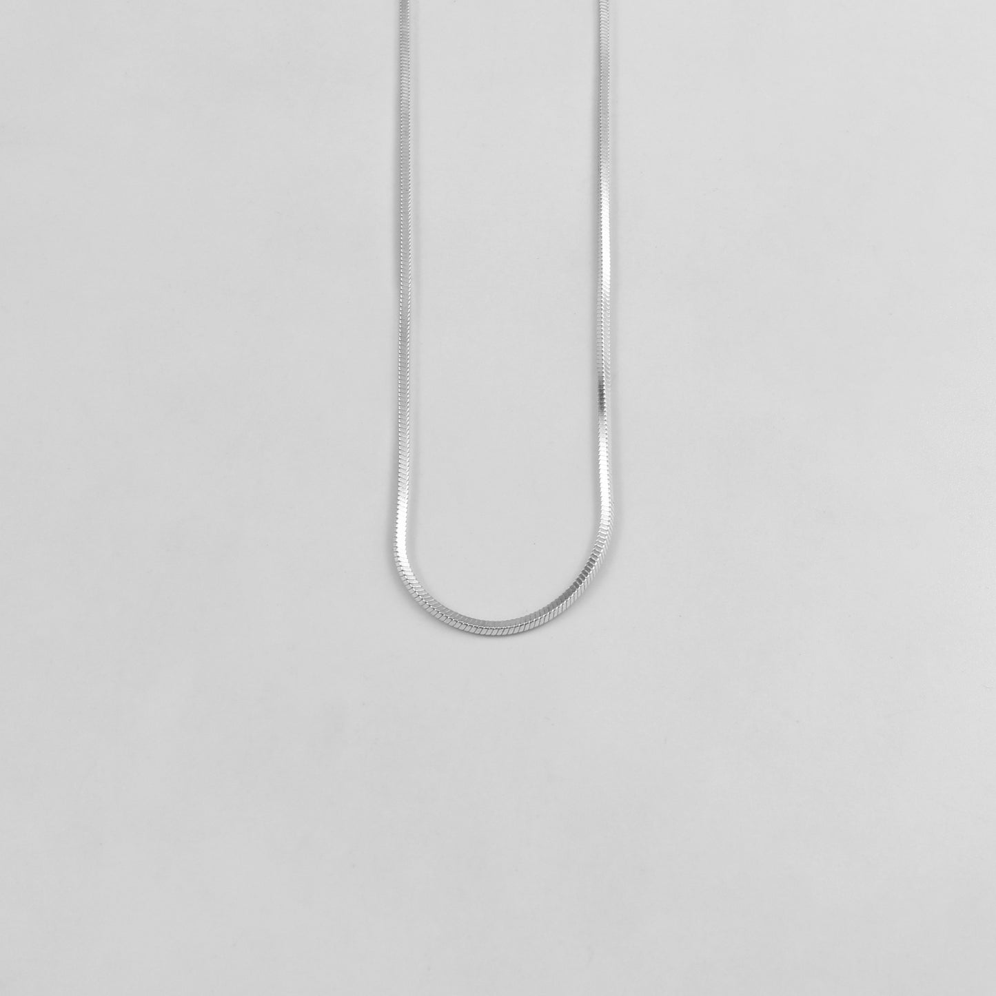 925 sterling silver necklace named 'Radiant Veil,' featuring a graceful design that combines flowing lines with delicate sparkling accents. Its ethereal beauty evokes the elegance of a shimmering veil, making it a timeless and captivating accessory.
