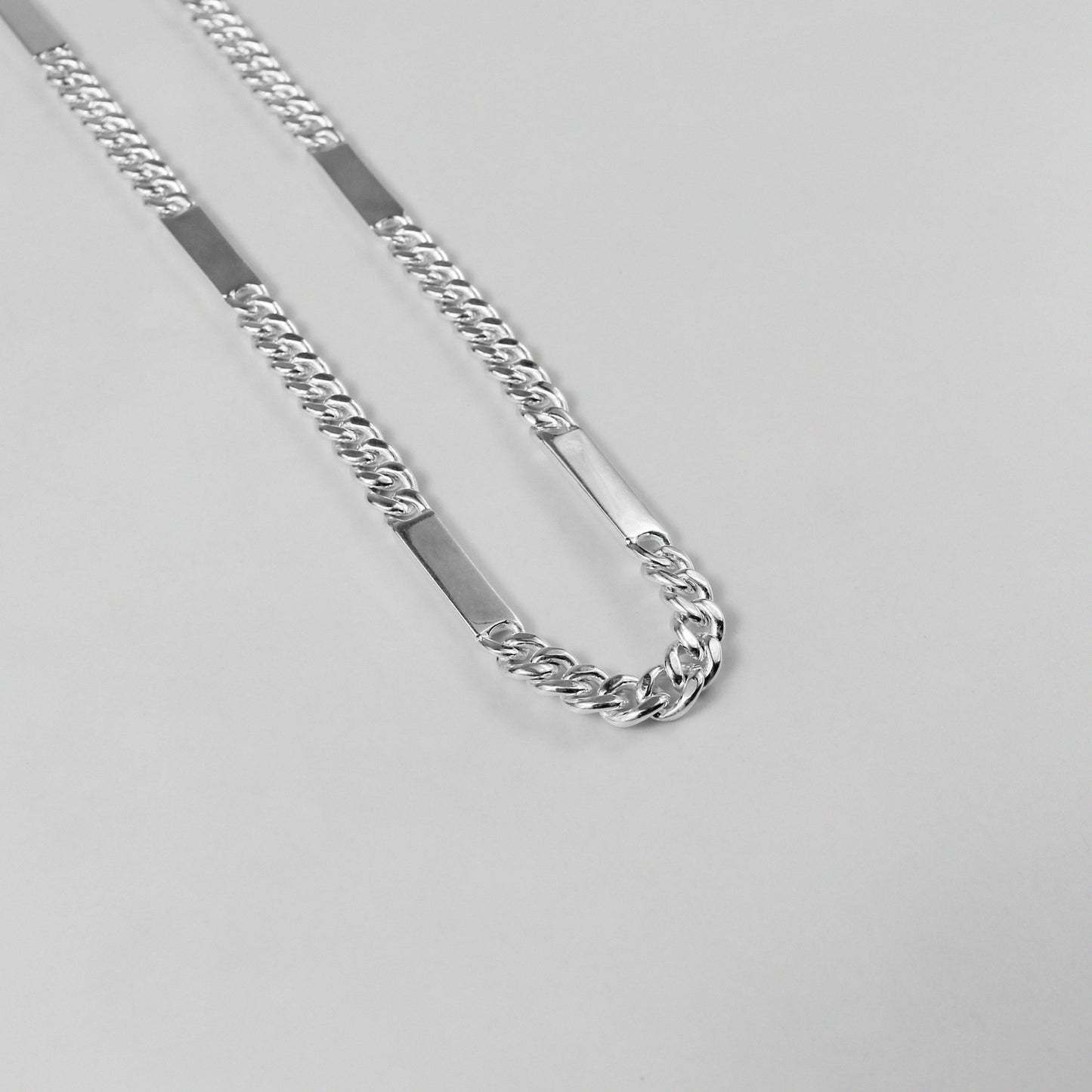 A modern necklace named 'RectaLink,' crafted from 925 sterling silver. Its design features sleek, rectangular links that create a bold and contemporary statement of style.