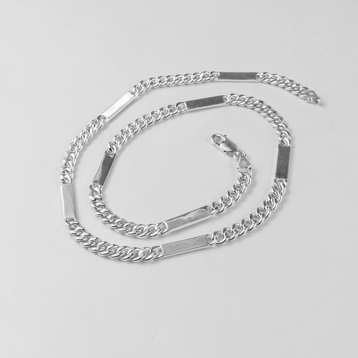 A modern necklace named 'RectaLink,' crafted from 925 sterling silver. Its design features sleek, rectangular links that create a bold and contemporary statement of style.
