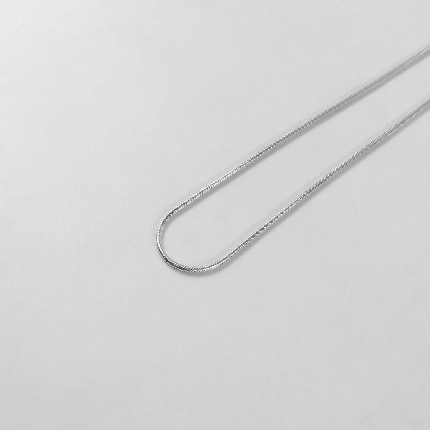 Round Snake Necklace - A refined 925 sterling silver necklace by GetTheJuice, showcasing a smooth and seamless round snake chain design that enhances any outfit with modern sophistication.