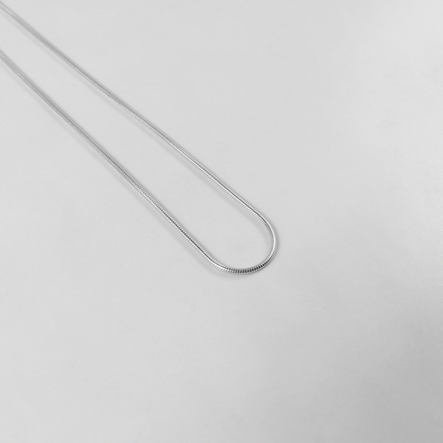 Round Snake Necklace - A refined 925 sterling silver necklace by GetTheJuice, showcasing a smooth and seamless round snake chain design that enhances any outfit with modern sophistication.