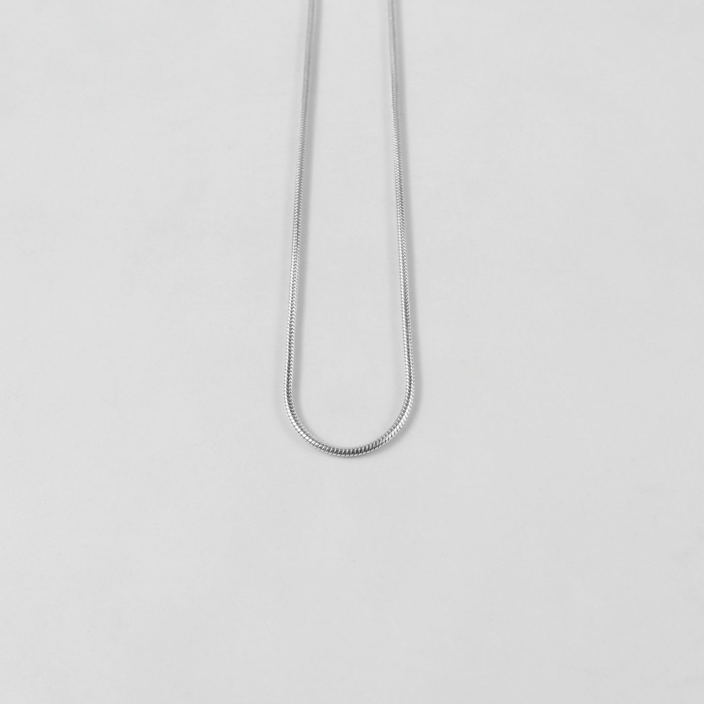 Round Snake Necklace - A refined 925 sterling silver necklace by GetTheJuice, showcasing a smooth and seamless round snake chain design that enhances any outfit with modern sophistication.