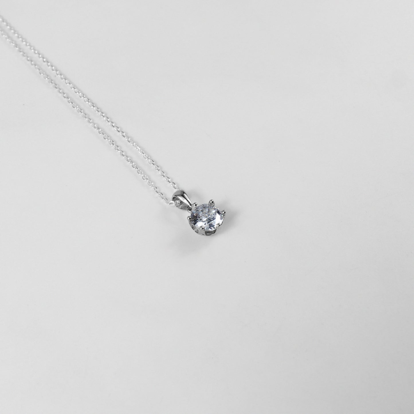 A refined necklace named 'Serenite,' crafted from 925 sterling silver. Its minimalist design embodies tranquility and grace, making it a versatile and elegant accessory.