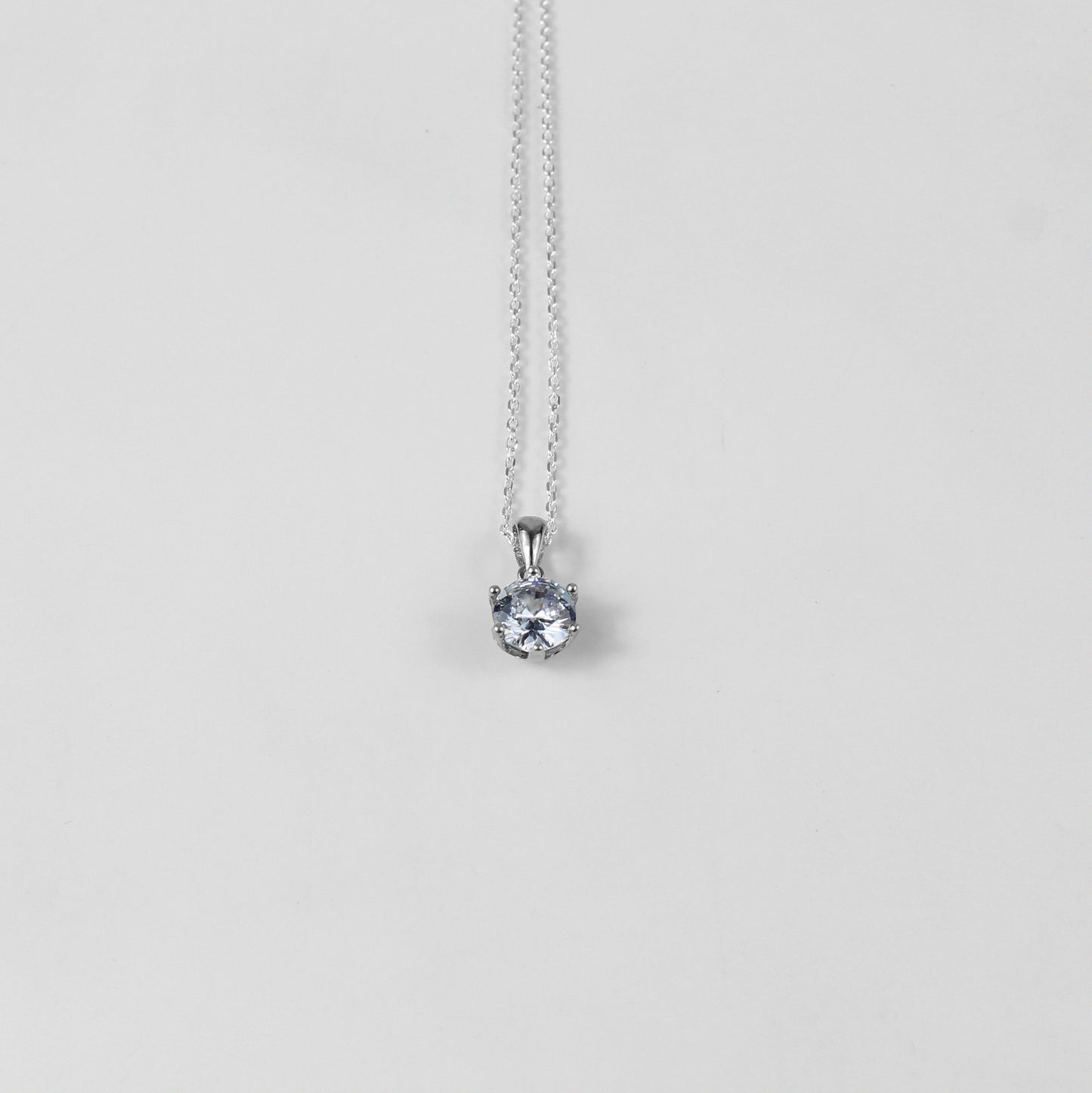 A refined necklace named 'Serenite,' crafted from 925 sterling silver. Its minimalist design embodies tranquility and grace, making it a versatile and elegant accessory.