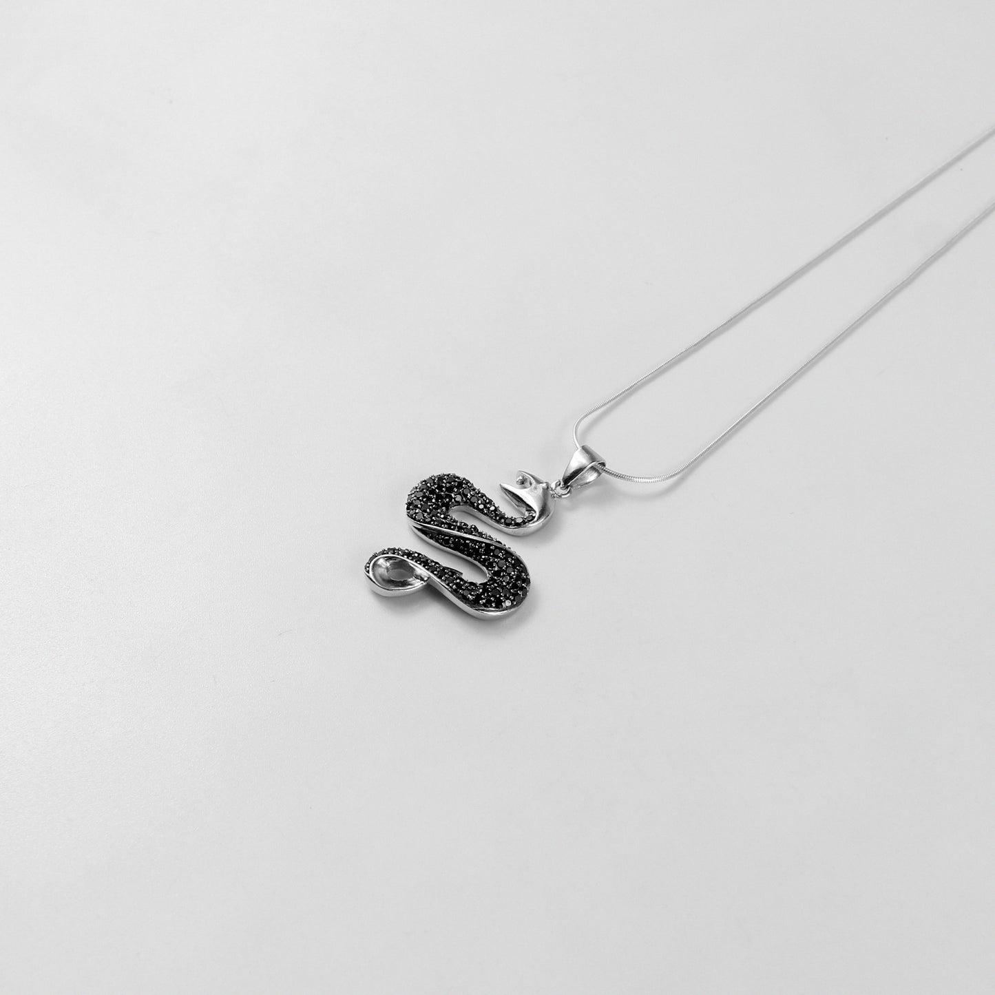 925 sterling silver necklace named 'Shadow Serpent,' featuring a sleek and sinuous design inspired by the graceful yet mysterious movement of a serpent. Its bold and enigmatic craftsmanship exudes a striking balance of elegance and edge, perfect for making a statement.