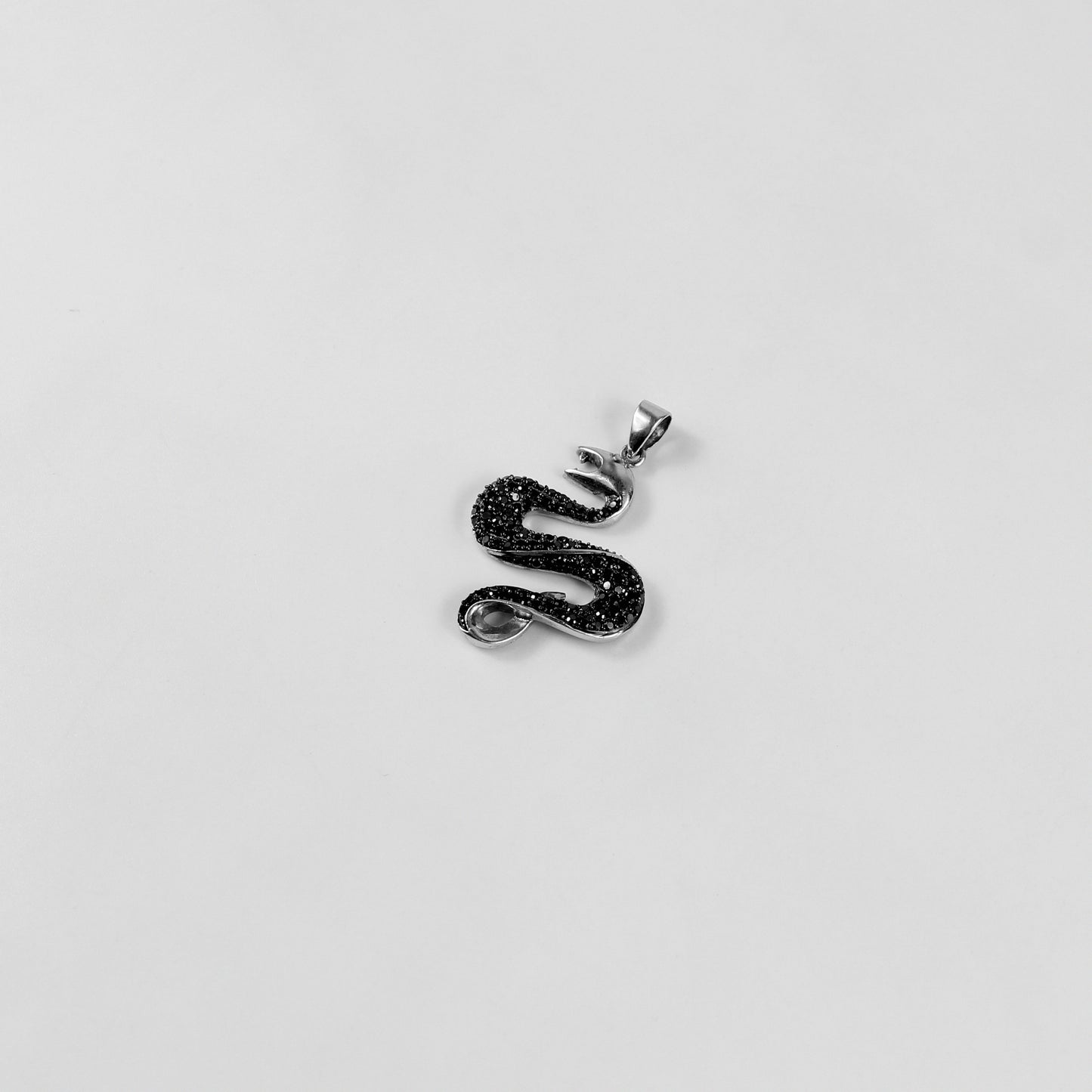 925 sterling silver necklace named 'Shadow Serpent,' featuring a sleek and sinuous design inspired by the graceful yet mysterious movement of a serpent. Its bold and enigmatic craftsmanship exudes a striking balance of elegance and edge, perfect for making a statement.