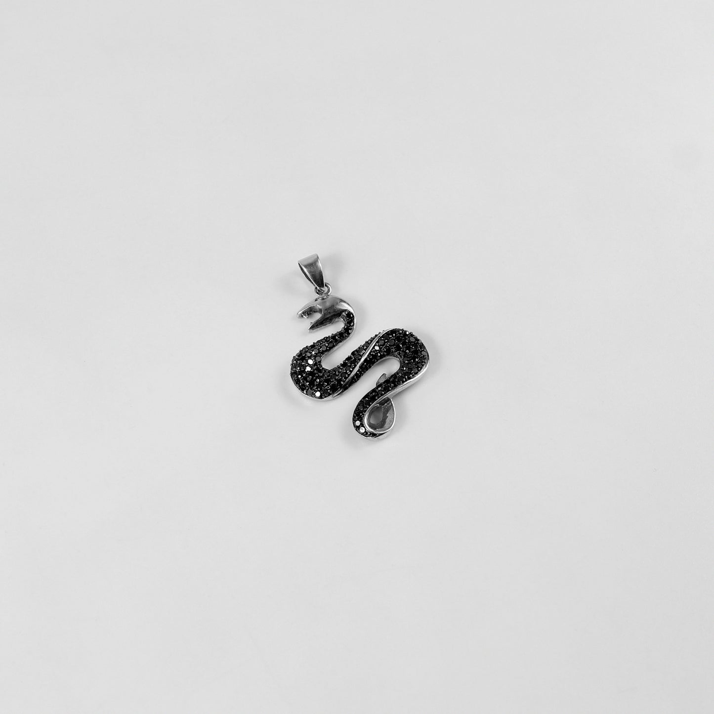 925 sterling silver necklace named 'Shadow Serpent,' featuring a sleek and sinuous design inspired by the graceful yet mysterious movement of a serpent. Its bold and enigmatic craftsmanship exudes a striking balance of elegance and edge, perfect for making a statement.