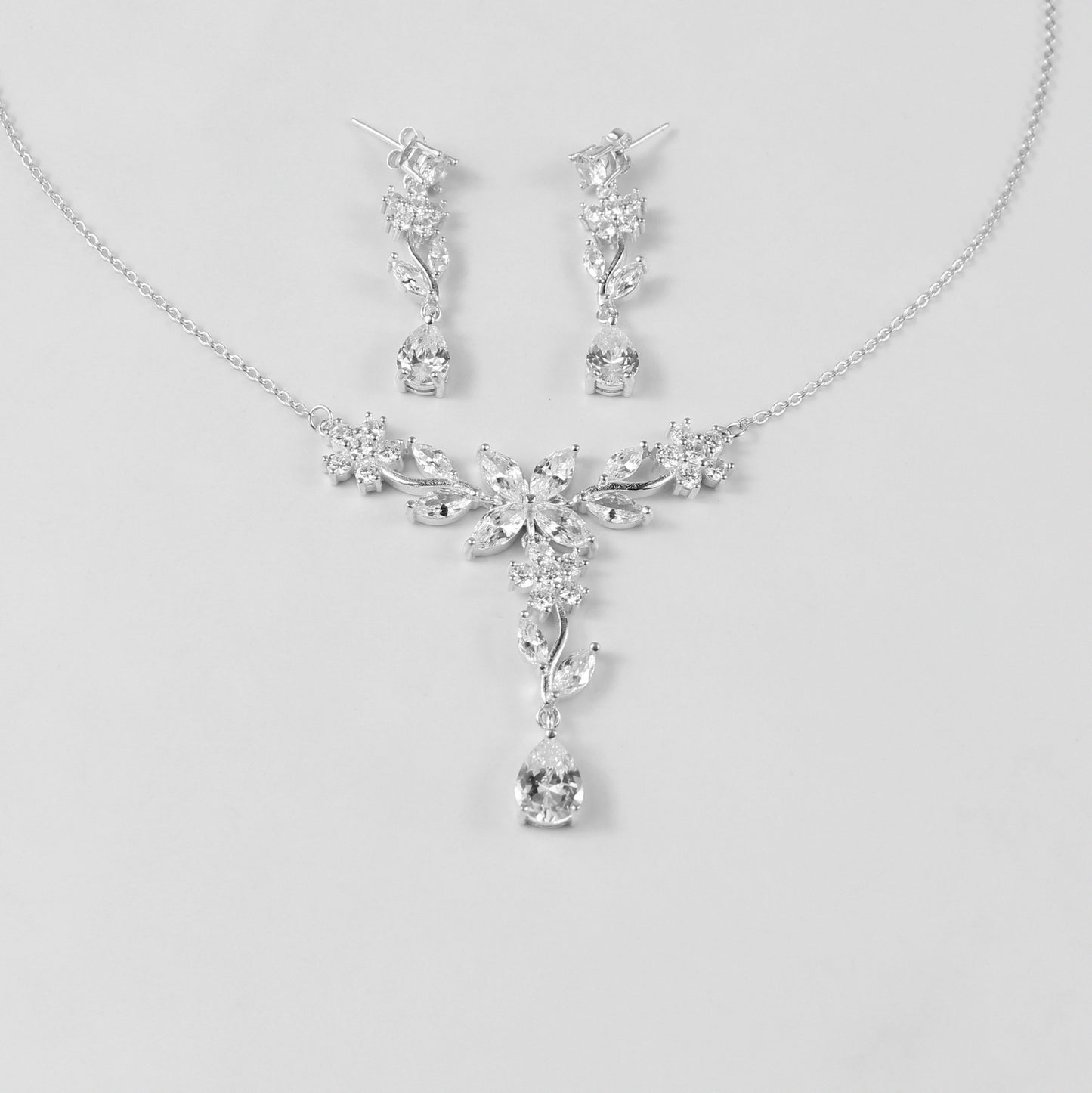 A delicate necklace featuring a floral-inspired design, crafted from 925 sterling silver, named 'Shimmer Bloom.' Its intricate detailing and elegant shimmer create a timeless and sophisticated accessory.