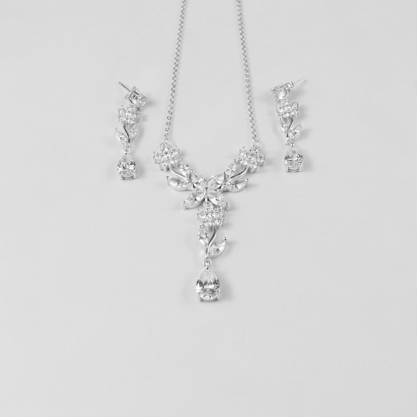 A delicate necklace featuring a floral-inspired design, crafted from 925 sterling silver, named 'Shimmer Bloom.' Its intricate detailing and elegant shimmer create a timeless and sophisticated accessory.