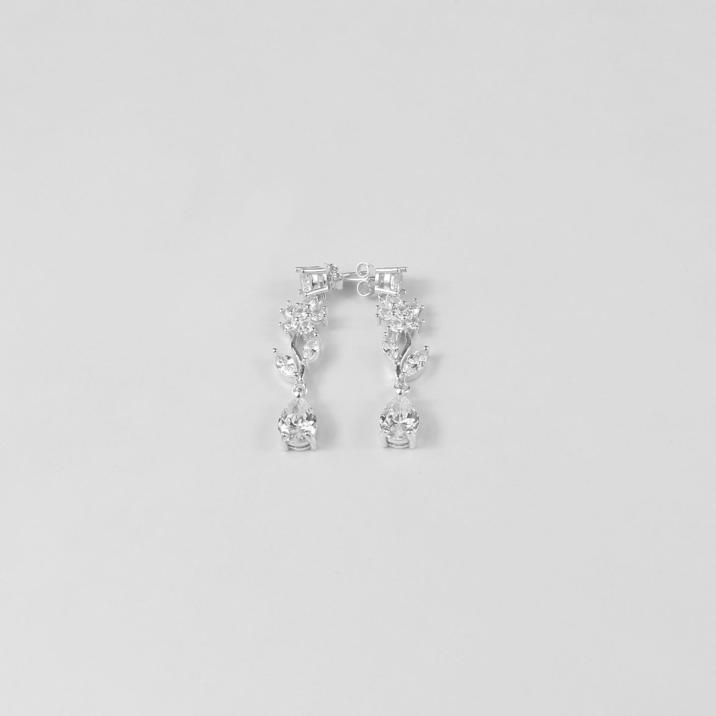 A delicate necklace featuring a floral-inspired design, crafted from 925 sterling silver, named 'Shimmer Bloom.' Its intricate detailing and elegant shimmer create a timeless and sophisticated accessory.