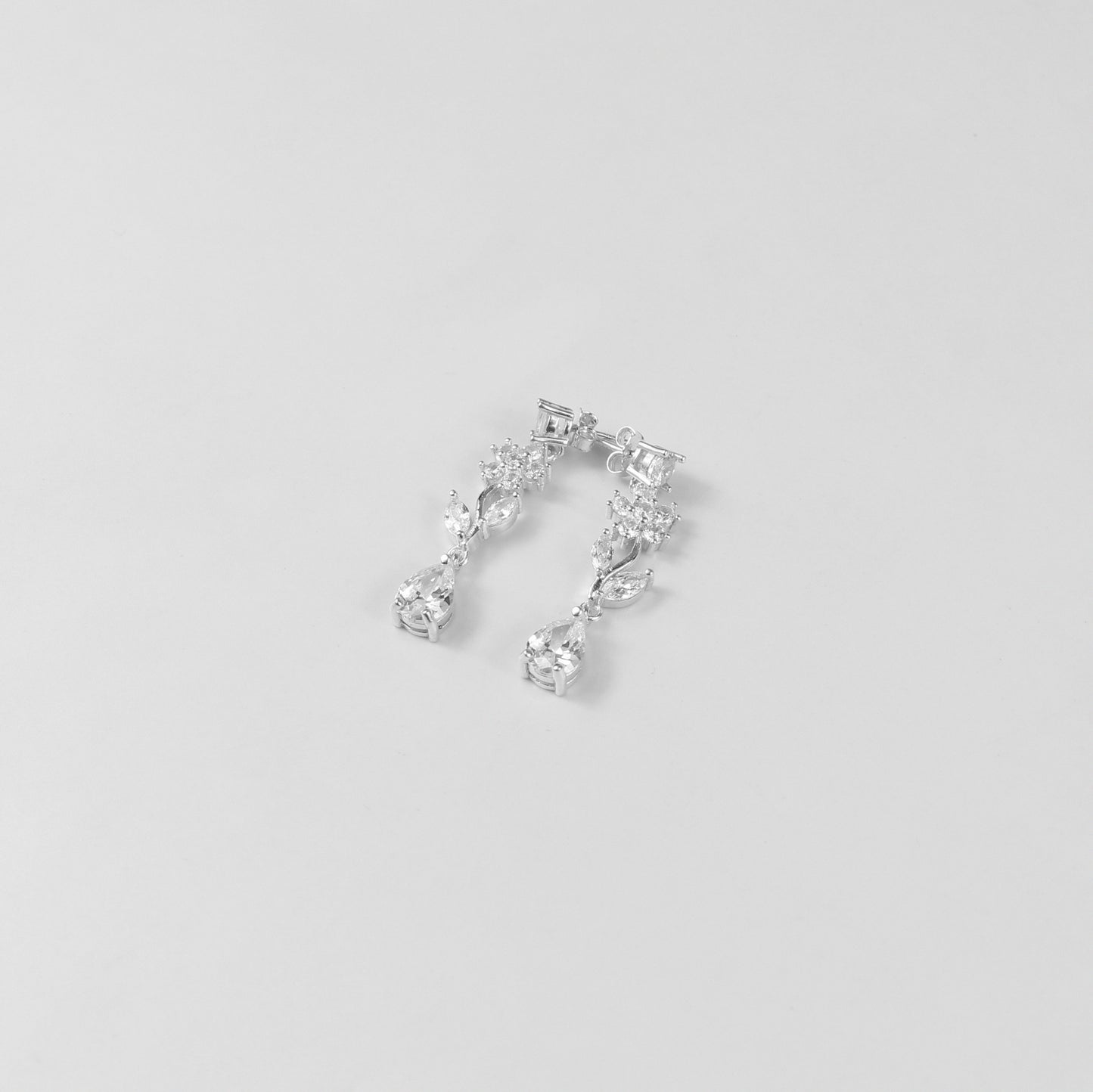 A delicate necklace featuring a floral-inspired design, crafted from 925 sterling silver, named 'Shimmer Bloom.' Its intricate detailing and elegant shimmer create a timeless and sophisticated accessory.