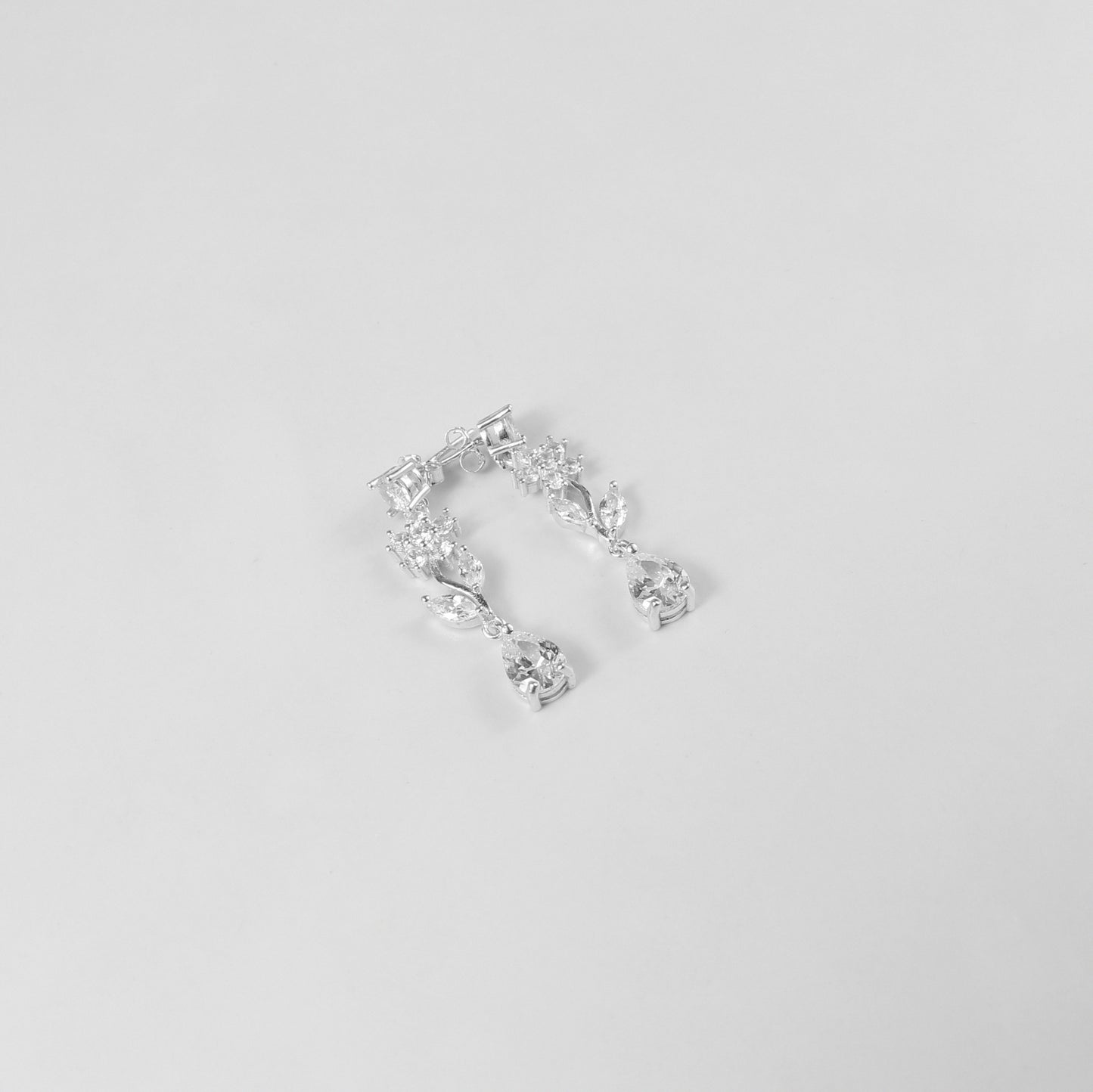 A delicate necklace featuring a floral-inspired design, crafted from 925 sterling silver, named 'Shimmer Bloom.' Its intricate detailing and elegant shimmer create a timeless and sophisticated accessory.