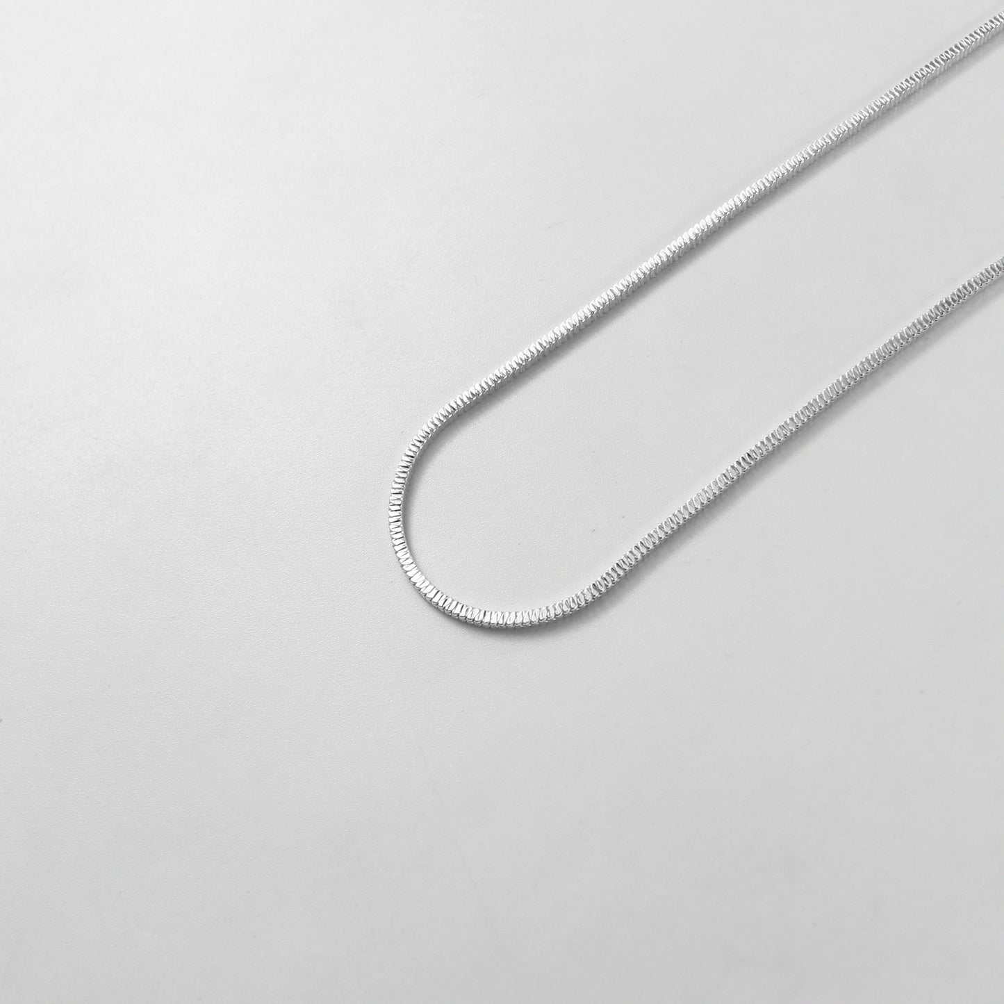The 'Square Snake' necklace, crafted from 925 sterling silver, featuring a bold and unique geometric design inspired by the elegance of a coiled snake.