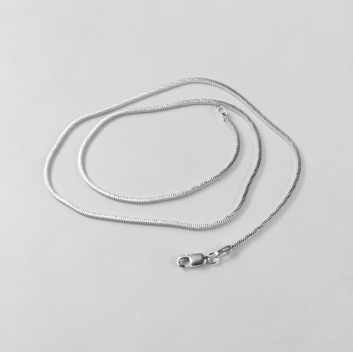 The 'Square Snake' necklace, crafted from 925 sterling silver, featuring a bold and unique geometric design inspired by the elegance of a coiled snake.