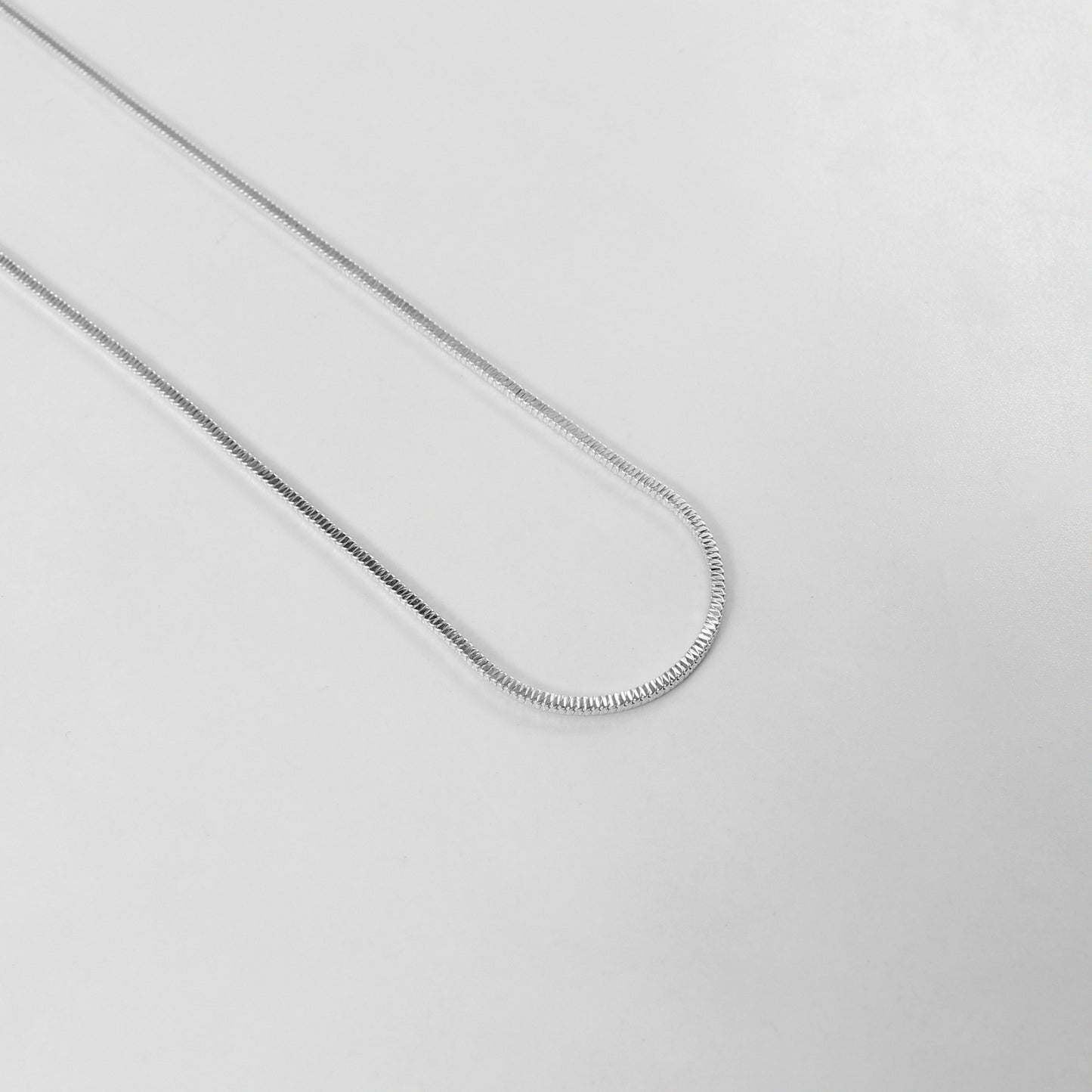 The 'Square Snake' necklace, crafted from 925 sterling silver, featuring a bold and unique geometric design inspired by the elegance of a coiled snake.