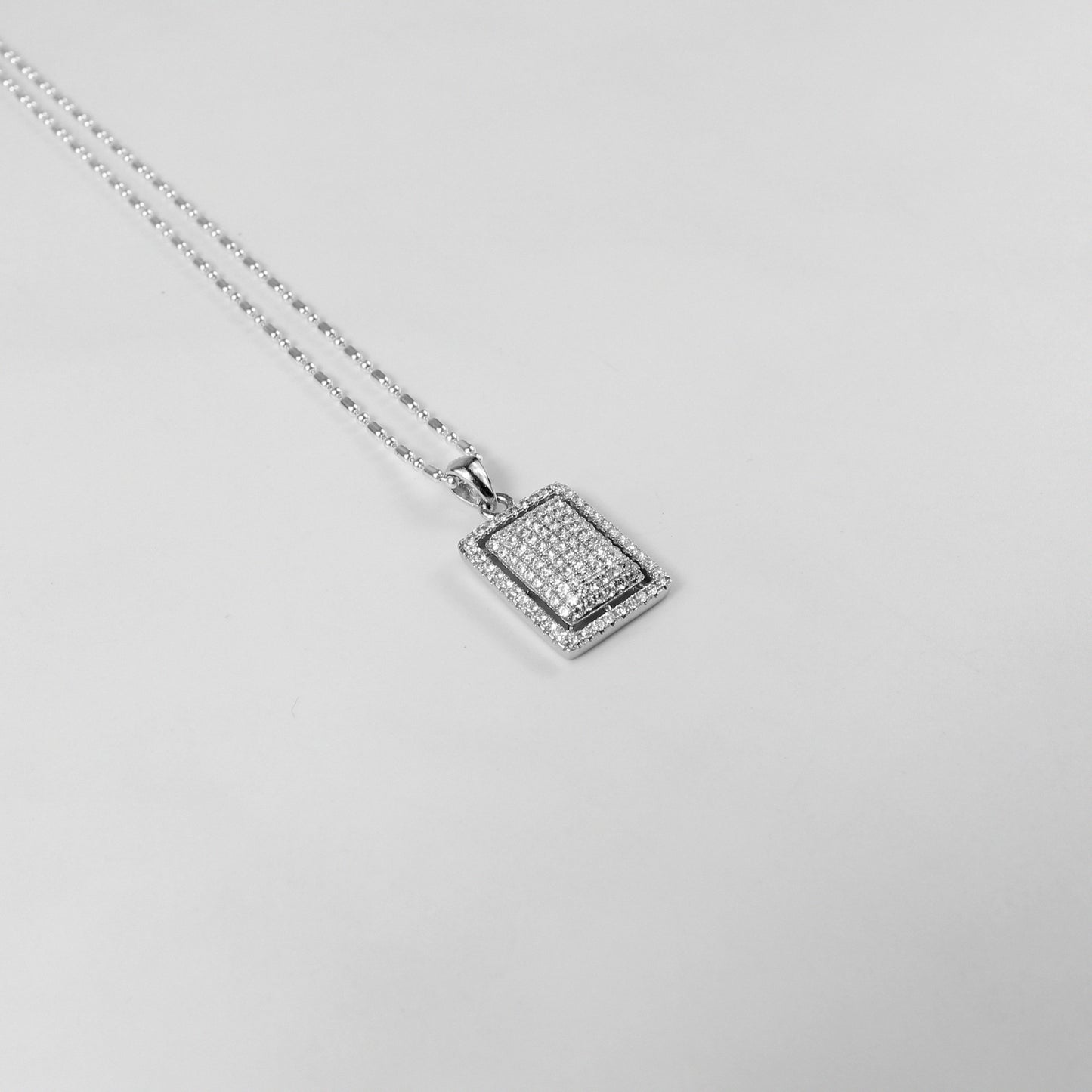 An enchanting necklace named 'Stella Luxe,' featuring intricate details in 925 sterling silver, capturing the luminous beauty of starlight in a luxurious form.