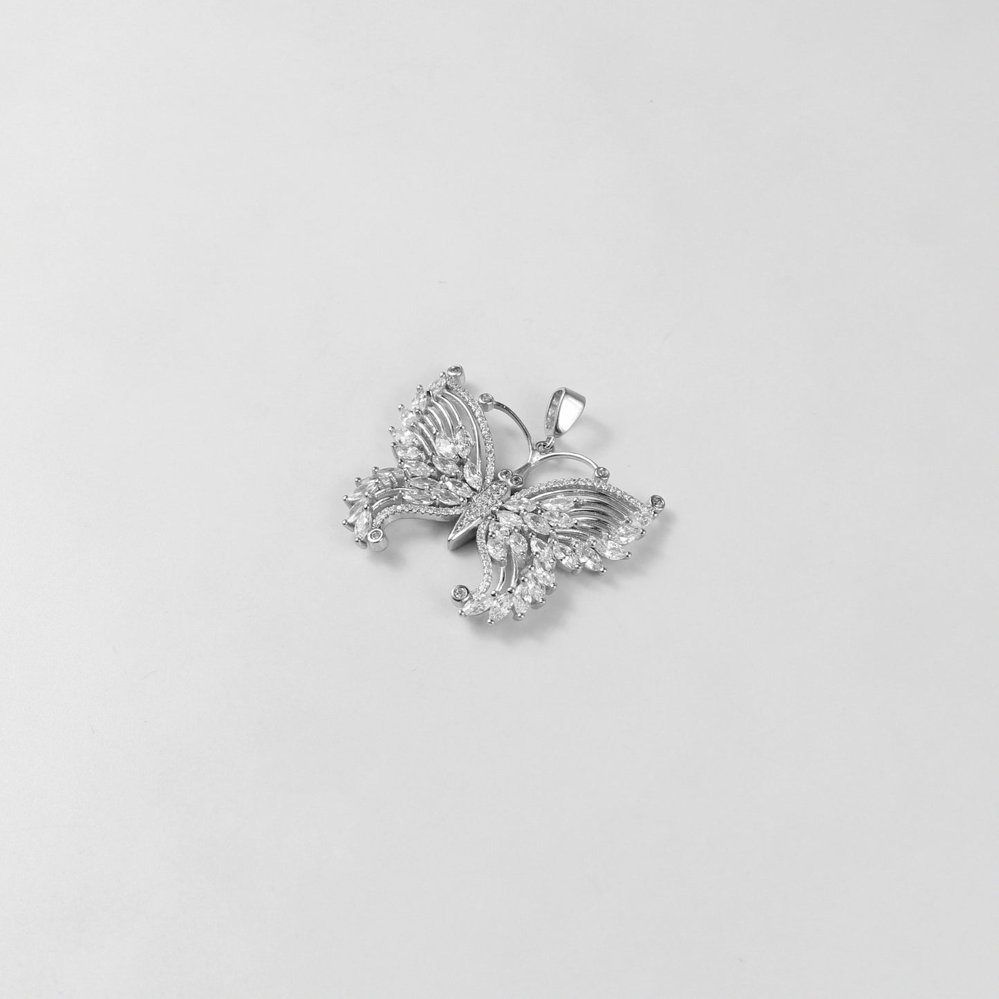 The 'Lunar Flutter' pendant, a luxurious 925 sterling silver creation, combining celestial motifs with a fluttering design for timeless charm.