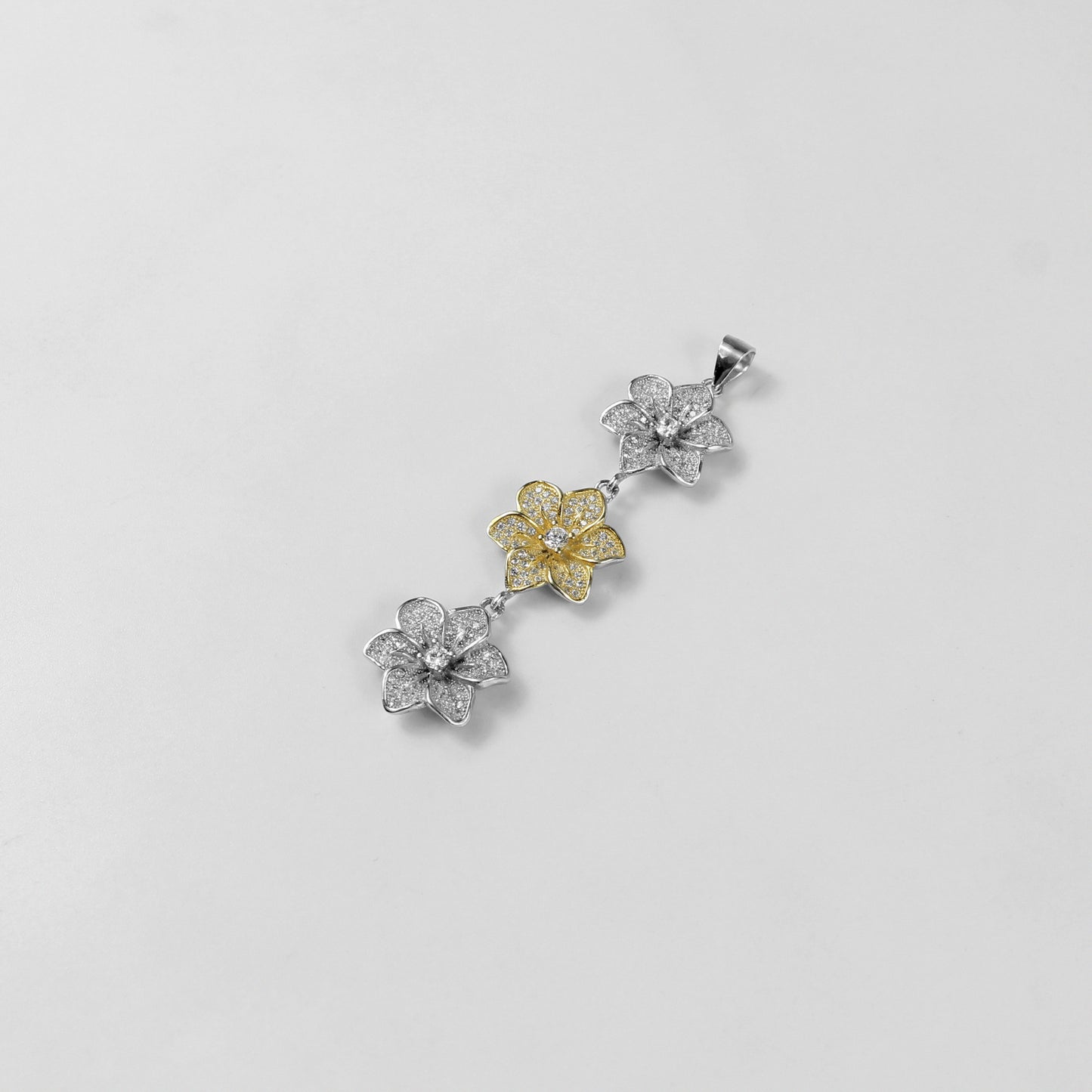 The 'Trinity Bloom' pendant, a graceful piece of 925 sterling silver jewelry, inspired by the beauty of three interconnected flowers representing unity.