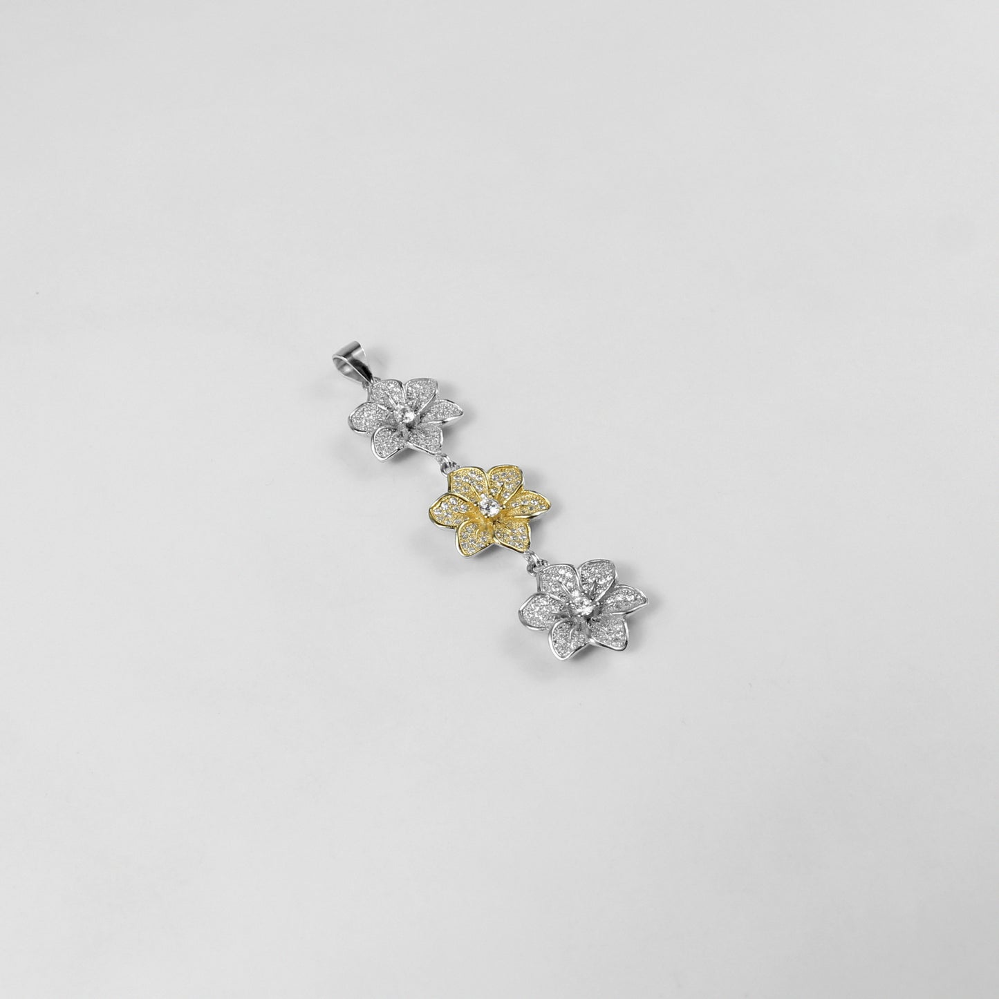 The 'Trinity Bloom' pendant, a graceful piece of 925 sterling silver jewelry, inspired by the beauty of three interconnected flowers representing unity.